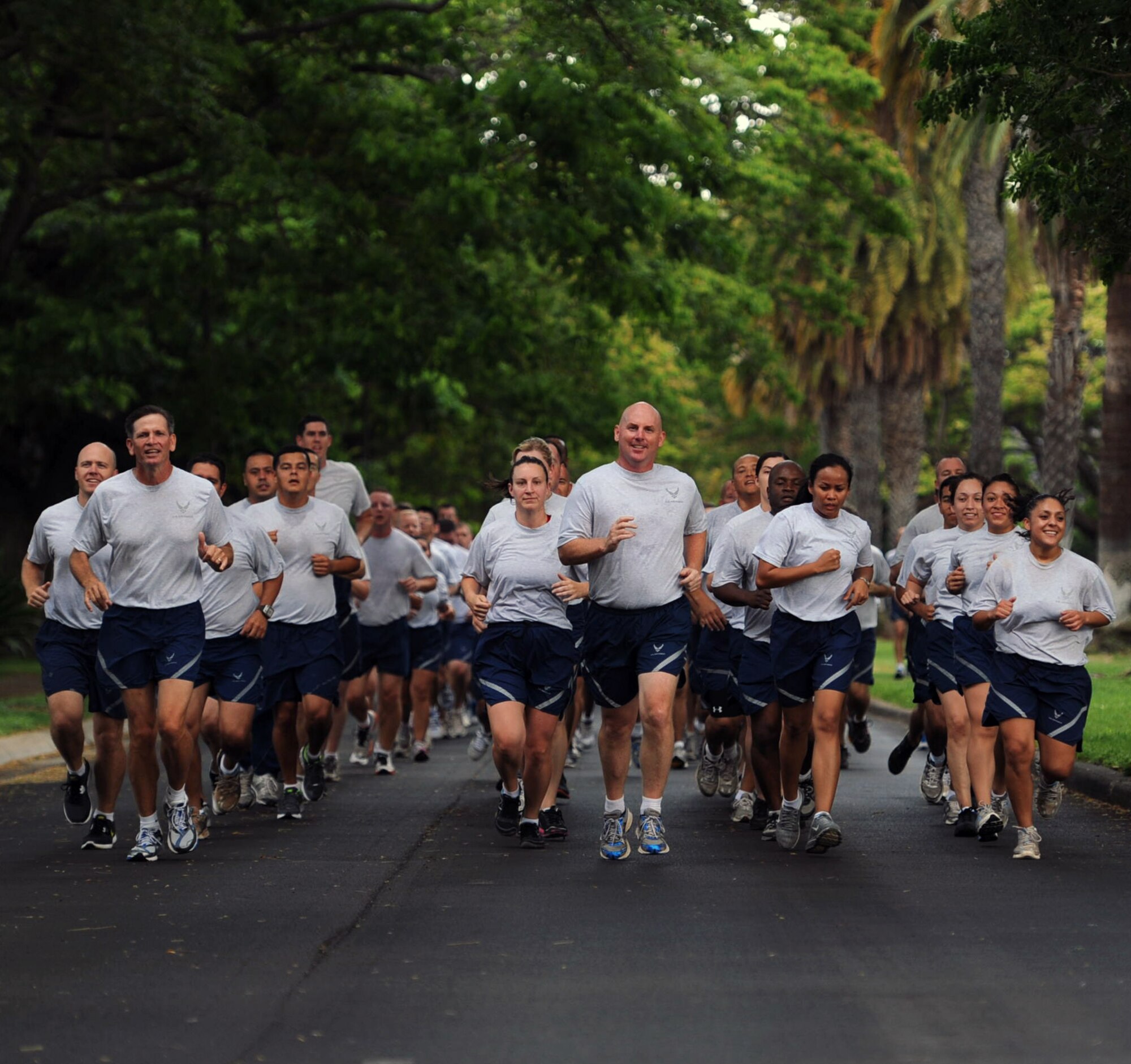 Col. Sam Barrett, 15th Wing commander, leads a formation of 15th Wing Airmen during the monthly Warrior Run June 1 at Joint Base Pearl Harbor Hickam, Hawaii. While the Warrior Run takes place monthly, this run marked the final time Barrett and Col. Joe Dague, 15th Wing vice commander, would participate while occupying those positions. (U.S. Air Force photo by Staff Sgt. Nathan Allen)