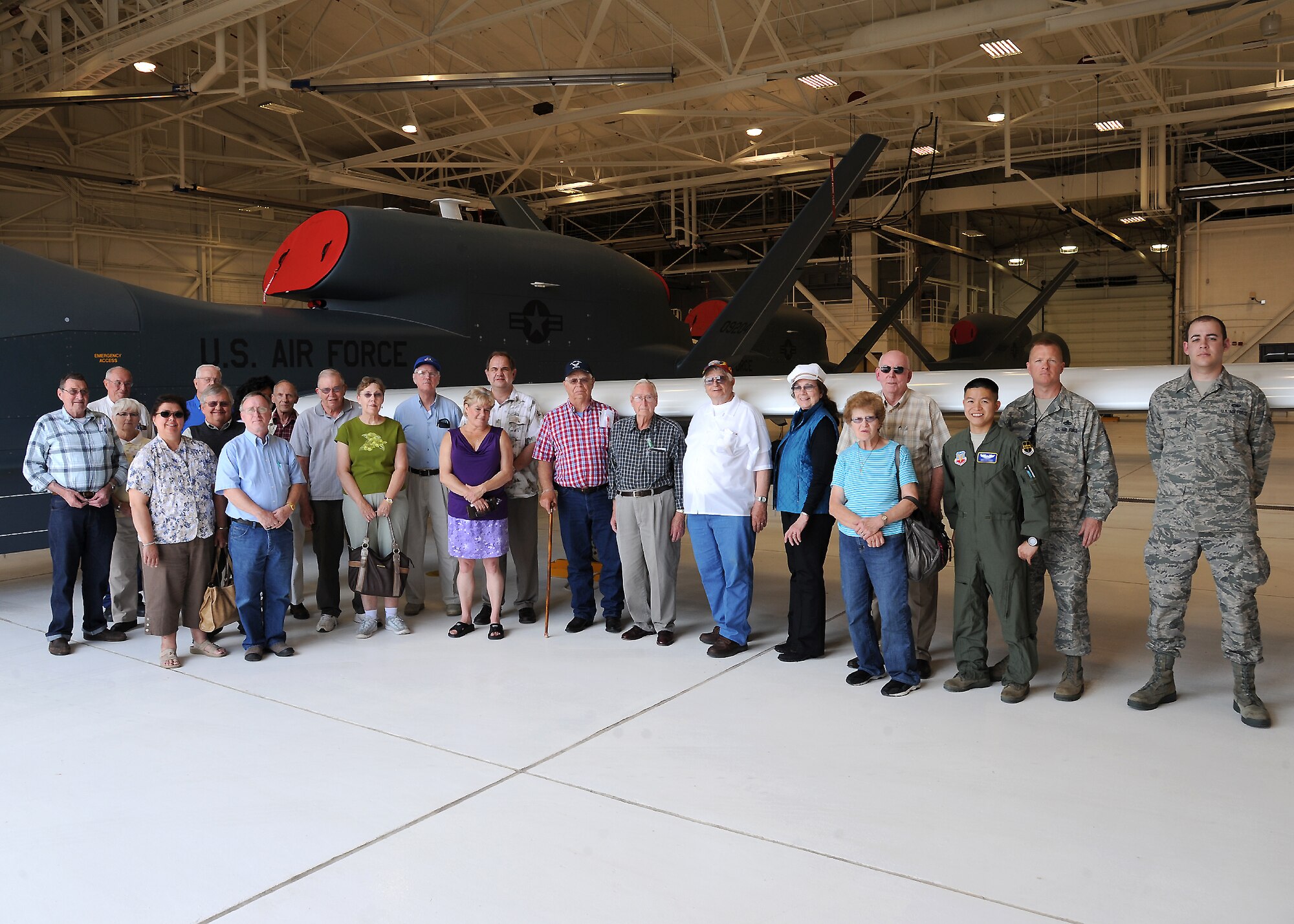 Retirees and their family members pose for a photo with members of the 69th Reconaissance Group in front of an RQ-4 Global Hawk during Military Retiree Appreciation Day on June 2, 2012, on Grand Forks Air Force Base, N.D. (U.S. Air Force photo/Airman 1st Class Derek VanHorn)