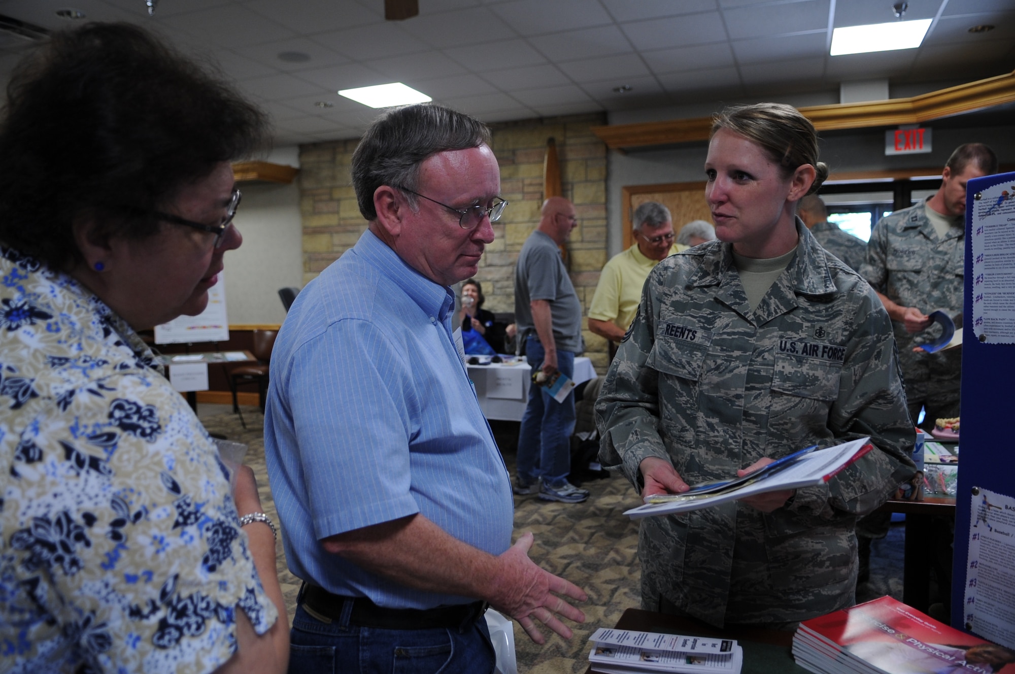 Tech. Sgt. Jaime Reents, 319th Medical Group, gives military retirees brochures during Military Retiree Appreciation Day on June 2, 2012, on Grand Forks Air Force Base, N.D.  (U.S. Air Force photo by Staff Sgt. Amanda Grabiec)