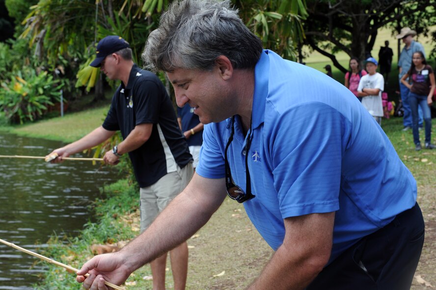 Bruce Shewalter, Friends of Hickam President, engages in a "fish-off" to kick off the beginning of the 2012 Keiki Fishing Tournament May 30 at Ho'omaluhia Botanical Gardens in Kaneohe, Hawaii. The fishing tournament was sponsored by the Friends of Hickam, a group of community leaders who facilitate between the 15th Wing at Joint Base Pearl Harbor-Hickam, Hawaii, and the Hawaii community seeking to support, promote, and foster stronger community relations with those associated with the 15th Wing. (U.S. Air Force photo by Staff Sgt. Nathan Allen)