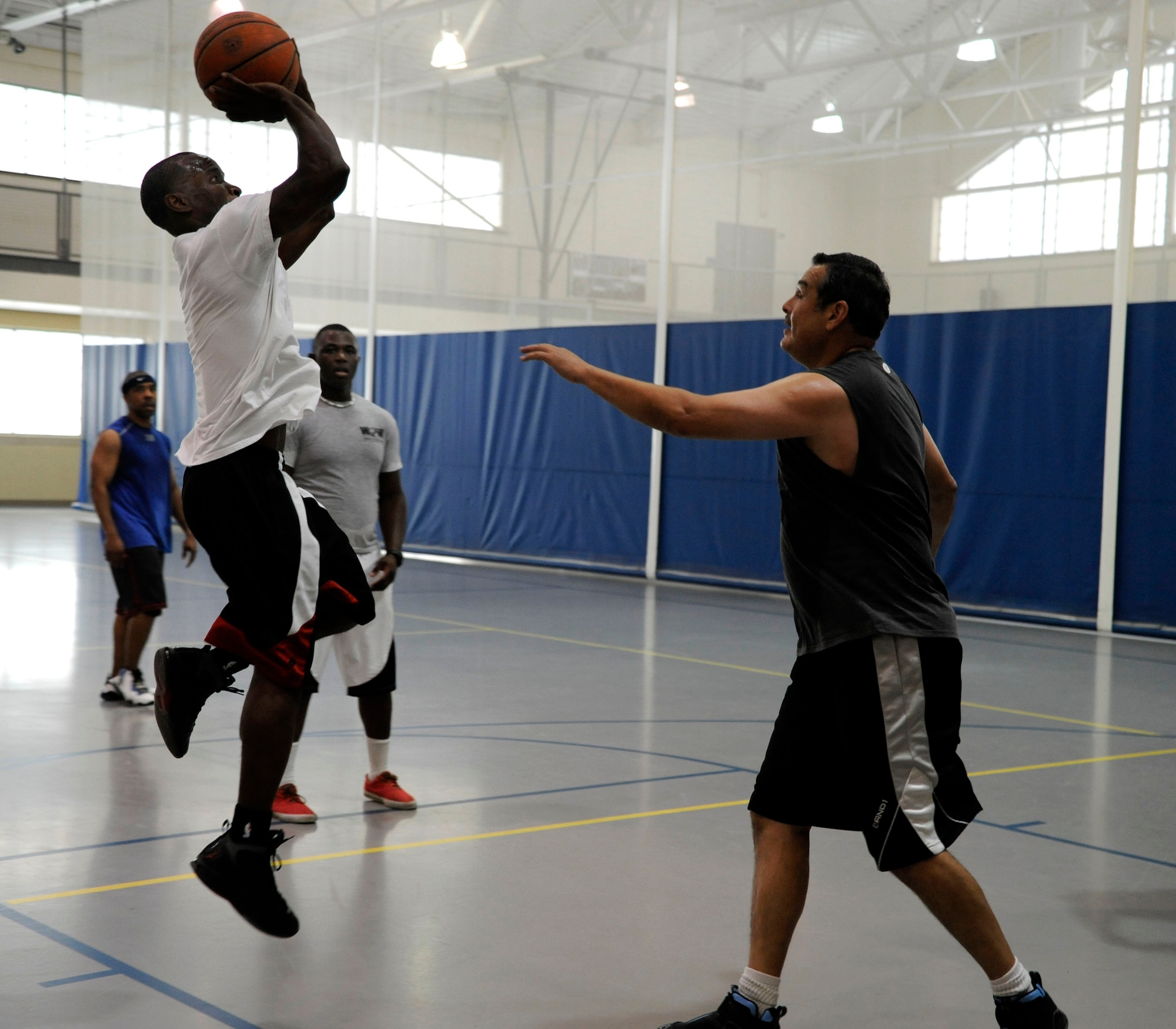 Sgt. John Youngblood, 39th Military Police Company, takes a shot during a game of basketball on Barksdale Air Force Base La., June 4. Members from the U.S. Army, U.S. Navy, and U.S. Air Force stationed here competed in the friendly inter-service game at the fitness center. (U.S. Air Force photo/Airman 1st Class Andrew Moua)(RELEASED)