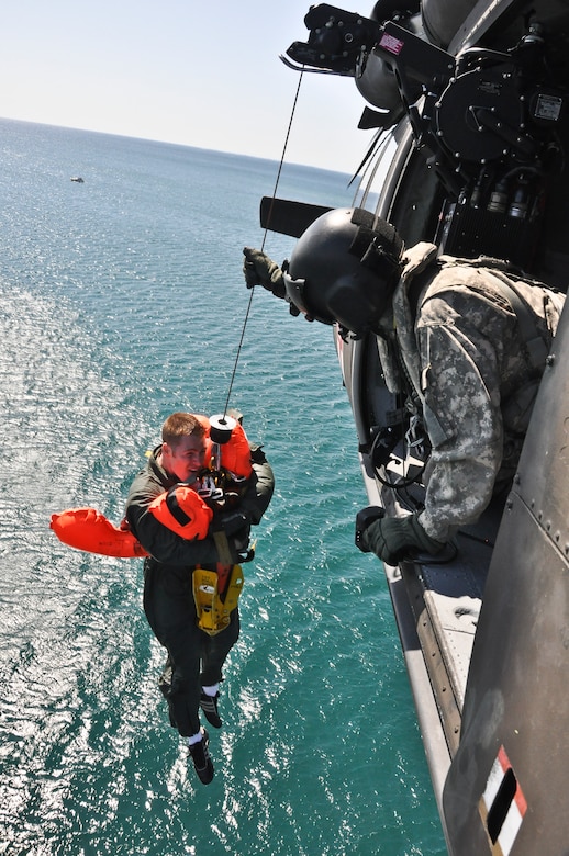 UH-60 Black Hawk Helicopter Crew Chief Eric Leukert from the Army Aviation Supply Facility #1, West Bend, Wis., prepares to grab 128th Air Refueling Wing boom operator Staff Sgt. Ryan Reisen and pull him in to the Black Hawk to complete Reisen's safe 100-foot ascent from the waters of Lake Michigan, off the coast of Milwaukee during a joint water rescue training exercise on June 2, 2012. 

The water survival and extraction training was a joint exercise with support from the 128 ARW, AASF #1, Coast Guard, and Milwaukee Fire Dept. 

U.S. Air Force Photo by Staff: Sgt. Jeremy M. Wilson
