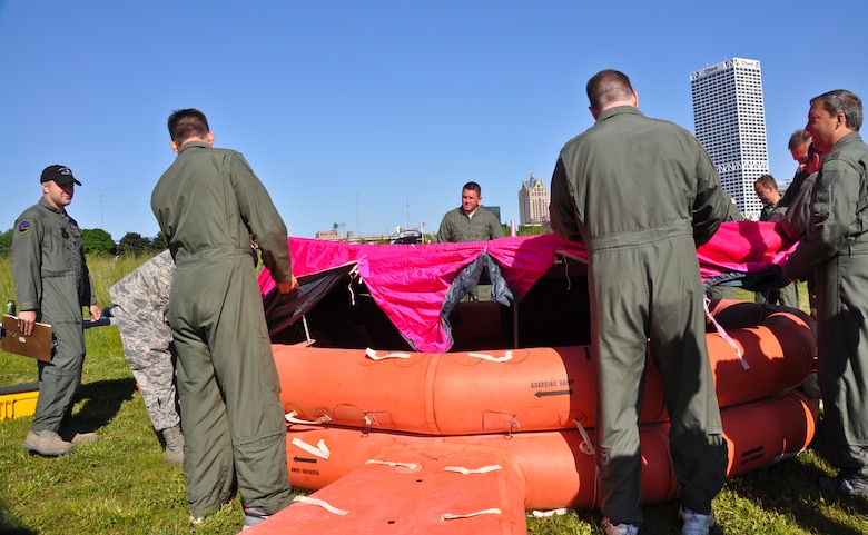 Under the supervision of Air Crew Flight Equipment's Tech. Sgt. Jordan Wescott, pilots and boom operators from the 128th Air Refueling Wing, Milwaukee construct an inflatable rescue raft and place a covering to be used for shade, water collection, and long range aerial visibility while prepping for water extraction in Lake Michigan, Wis., on Saturday, June 2, 2012.
The water survival and extraction training was a joint exercise with support from the 128ARW, UH-60 Black Hawk Helicopters from the Army Aviation Support Facility #1, West Bend, Wis., Coast Guard, and Milwaukee Fire Dept. 
U.S. Air Force Photo by: Staff Sgt. Jeremy M. Wilson

