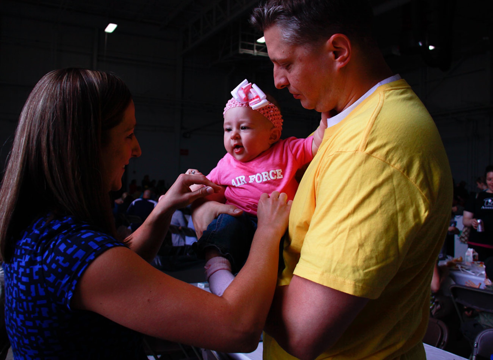 Capt. Dan DeCarlo, medical readiness officer, Aeromedical Evacuation Squadron, holds his 6-month-old daughter Madeline Rose DeCarlo during her first Family Day at the 911th Airlift Wing, June 3, 2012. DeCarlo, his wife Kelli and daughter Madeline enjoyed the music and food offered in Hangar 416 as well as the multiple attractions such as the static C-130 H-2 display and the Pittsburgh Zoo animals outside on the flightline. (U.S. Air Force photo by Airman 1st Class Justyne Obeldobel/Released) 


