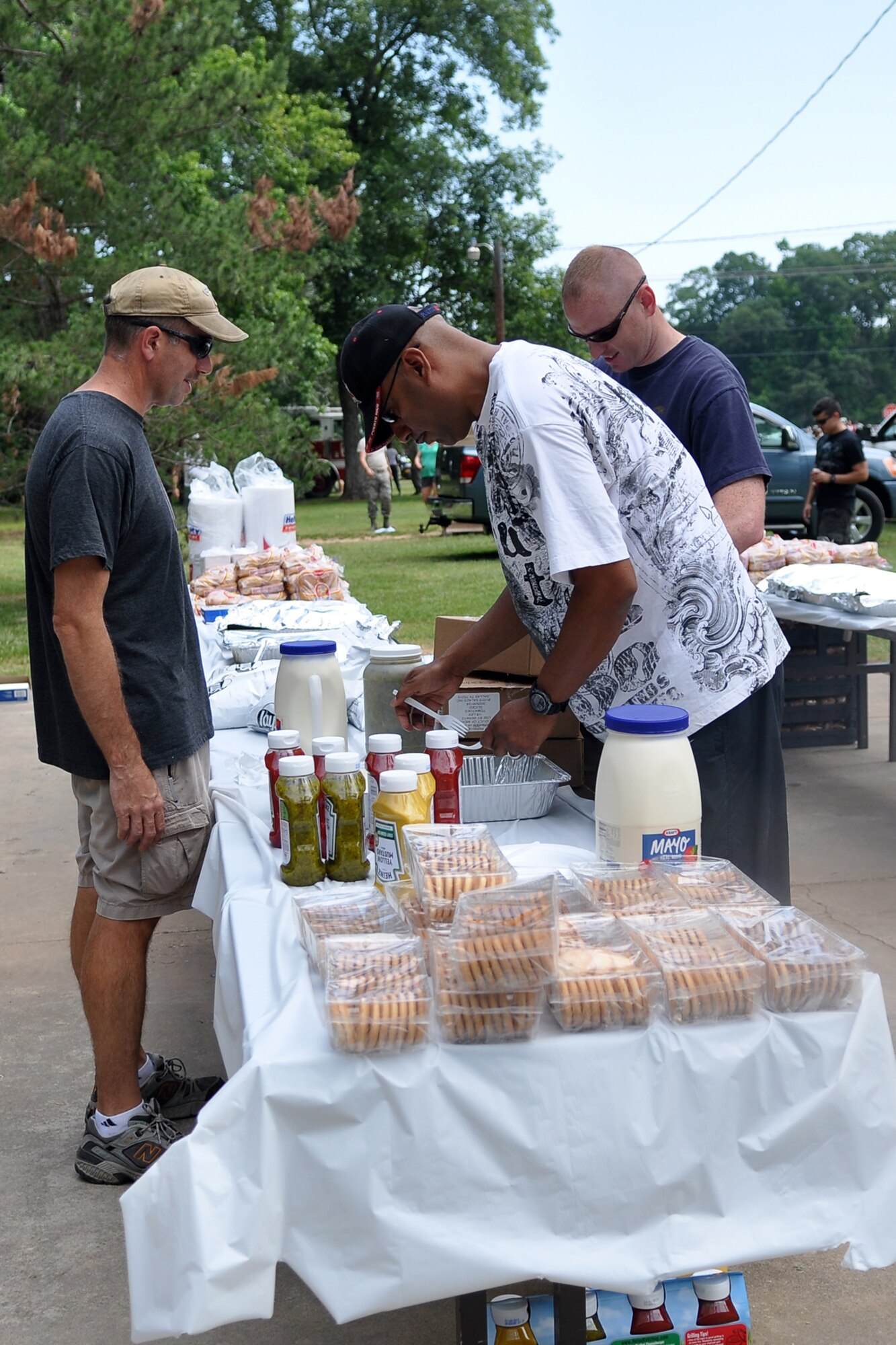 Event volunteers prepare the food lines for the 307th Bomb Wing/917th Fighter Group Family Day at Cullen Park on Barksdale Air Force Base, La., June 2, 2012. The annual event is an opportunity for the Reservists and their families to get together for some fun and camaraderie. (U.S. Air Force photo/Betty Stephens)