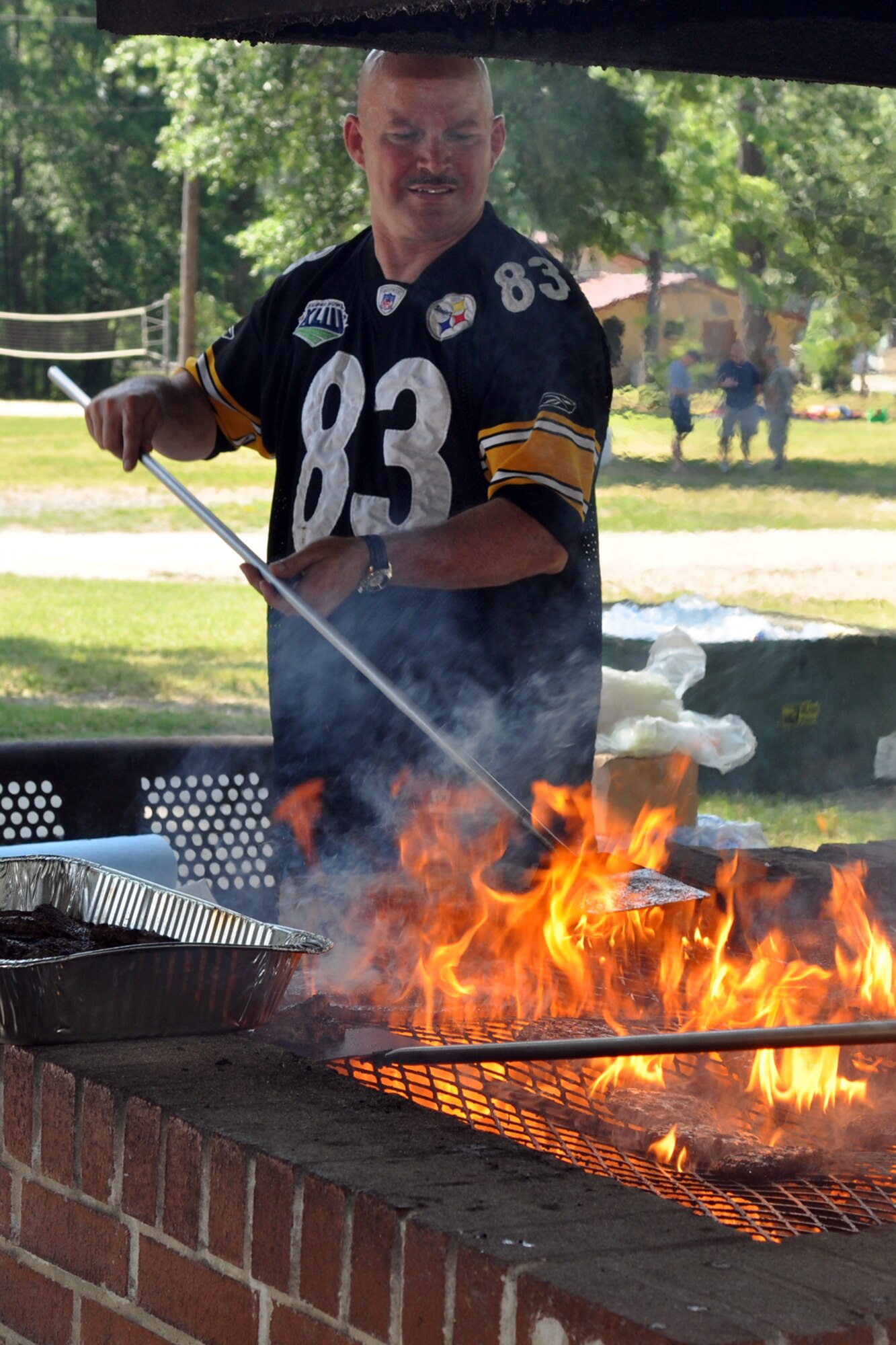 An event volunteer prepares food for the 307th Bomb Wing/917th Fighter Group Family Day at Cullen Park on Barksdale Air Force Base, La., June 2, 2012. The annual event is an opportunity for the Reservists and their families to get together for some fun and camaraderie. (U.S. Air Force photo/Betty Stephens)