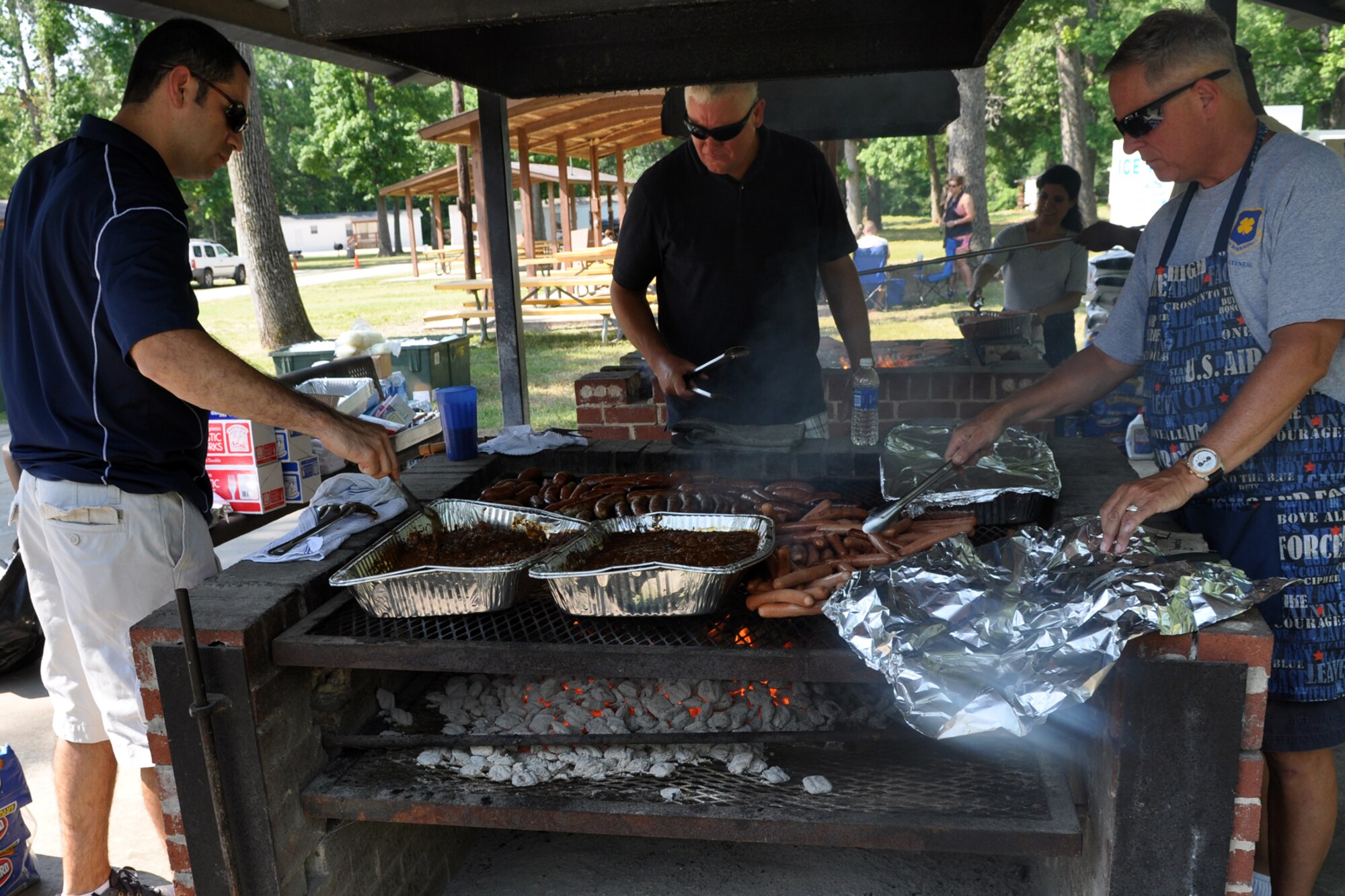 Event volunteers prepare food for the 307th Bomb Wing/917th Fighter Group Family Day at Cullen Park on Barksdale Air Force Base, La., June 2, 2012. The annual event is an opportunity for the Reservists and their families to get together for some fun and camaraderie. (U.S. Air Force photo/Betty Stephens)