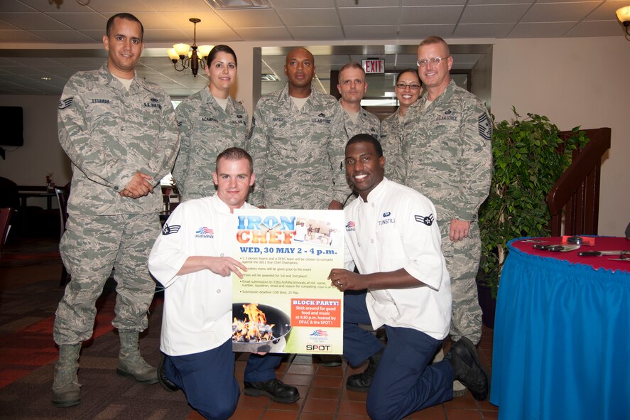 U.S. Air Force Senior Airman Robert Ehlers and Airman 1st Class Demetric Tunstill, Team Rob and Big members representing the 23d Force Support Squadron, pose with judges after the Iron Chef Competition at Moody Air Force Base, Ga., May 30, 2012. Ehlers and Tunstill became the second winners of the annual competition. The Georgia Pines Dining facility hosts the event to highlight the creativity of some of Moody's top chefs and boost morale within the unit. (U.S. Air Force photo by Airman 1st Class Paul Francis/Released)