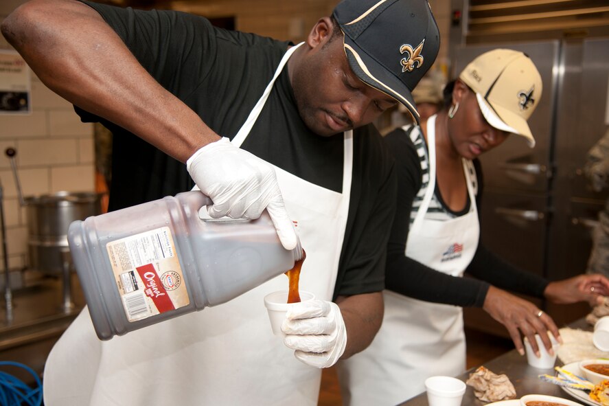 U.S. Air Force Tech Sgt. Melvin Spriggs and his wife Althea prepares ingredients during the Iron Chef Competition at Moody Air Force Base, Ga., May 30, 2012. The competition was hosted by the 23d Force Support Squadron and had four, two-person teams go head-to-head to see who made the best barbeque-style dish. (U.S. Air Force photo by Airman 1st Class Paul Francis/Released) 
