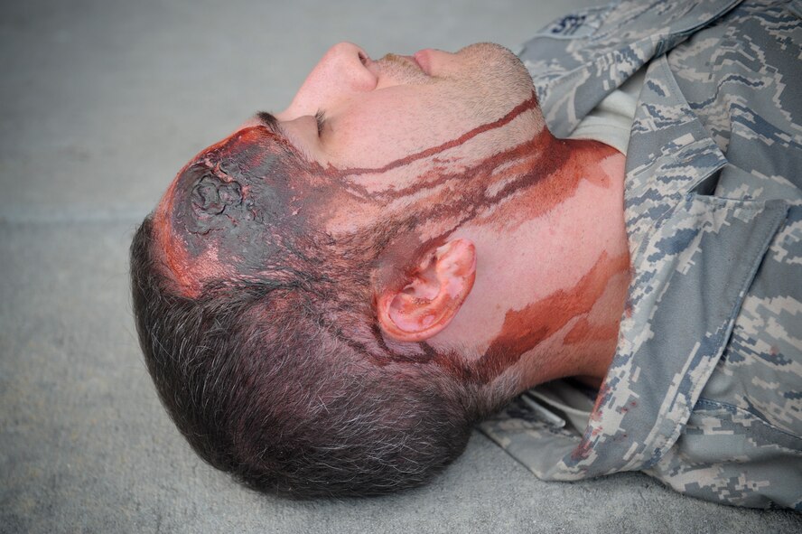 U.S. Air Force Staff Sgt. Victor Hawkins, 347th Rescue Group knowledge operator, plays the role of a gunshot victim during an active shooter exercise at Moody Air Force Base, Ga., June 1, 2012. Emergency medical personnel helped the wounded before evacuating victims who were pronounced dead. (U.S. Air Force photo by Airman 1st Class Douglas Ellis/Released)     
