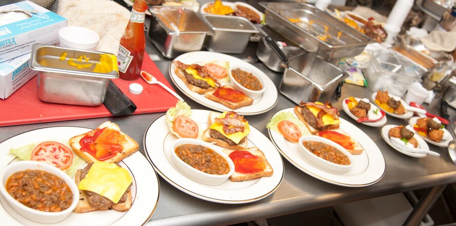 Plates of barbeque-style dishes sit after preparation during the second annual Iron Chef Competition at Moody Air Force Base, Ga., May 30, 2012. Sausage was the secret ingredient and had to be used in at least one of the meals served to the judges. (U.S. Air Force photo by Airman 1st Class Paul Francis/Released)
