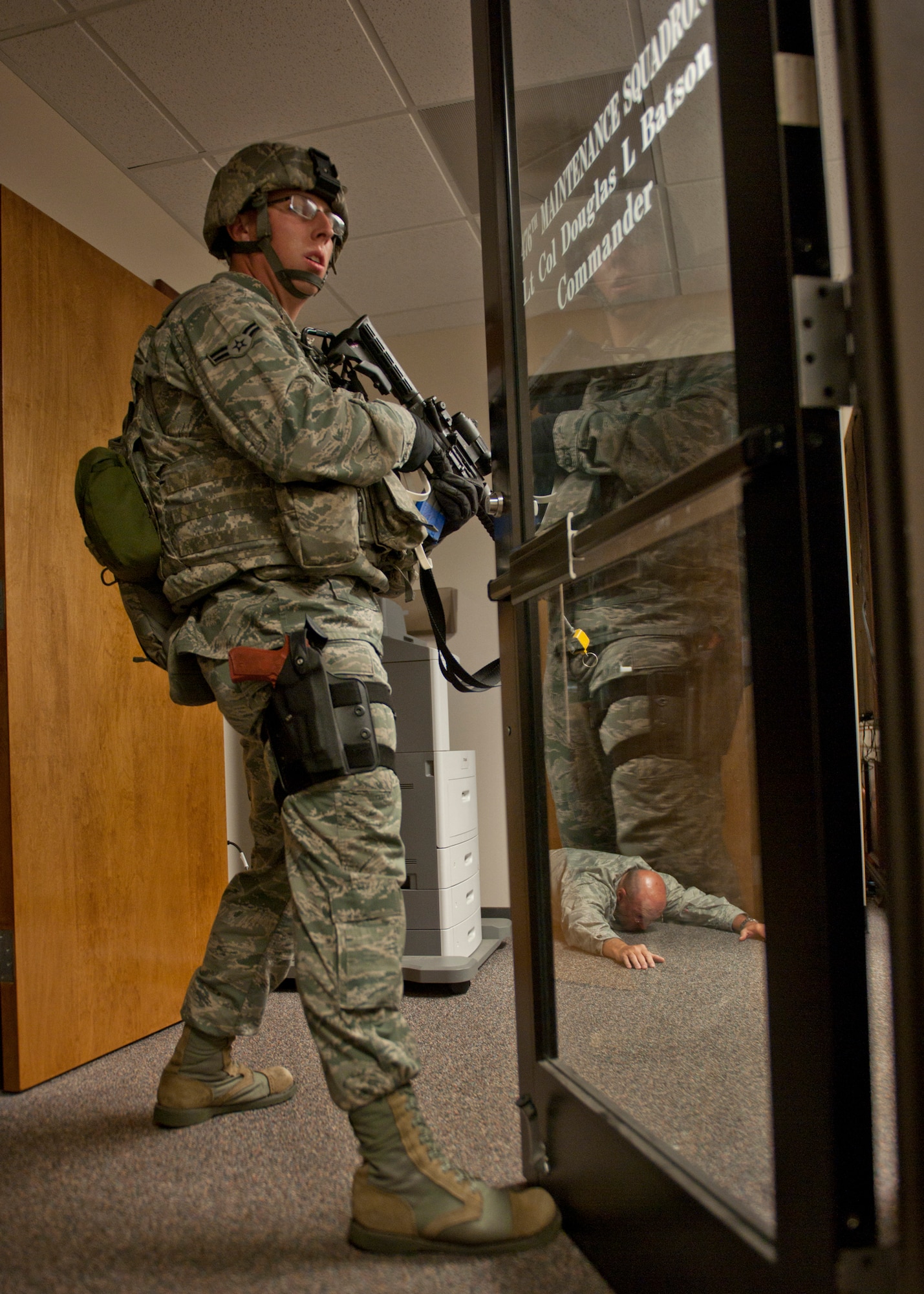 U.S. Air Force Airman 1st Class Jordan Patterson, 23d Security Forces Squadron, instructs everyone to remain calm during an active shooter exercise June 1, 2012, at Moody Air Force Base, Ga. The exercise prepared Team Moody for real active shooters and how to prevent injuries and deaths. (U.S. Air Force photo by Senior Airman Eileen Meier/Released)