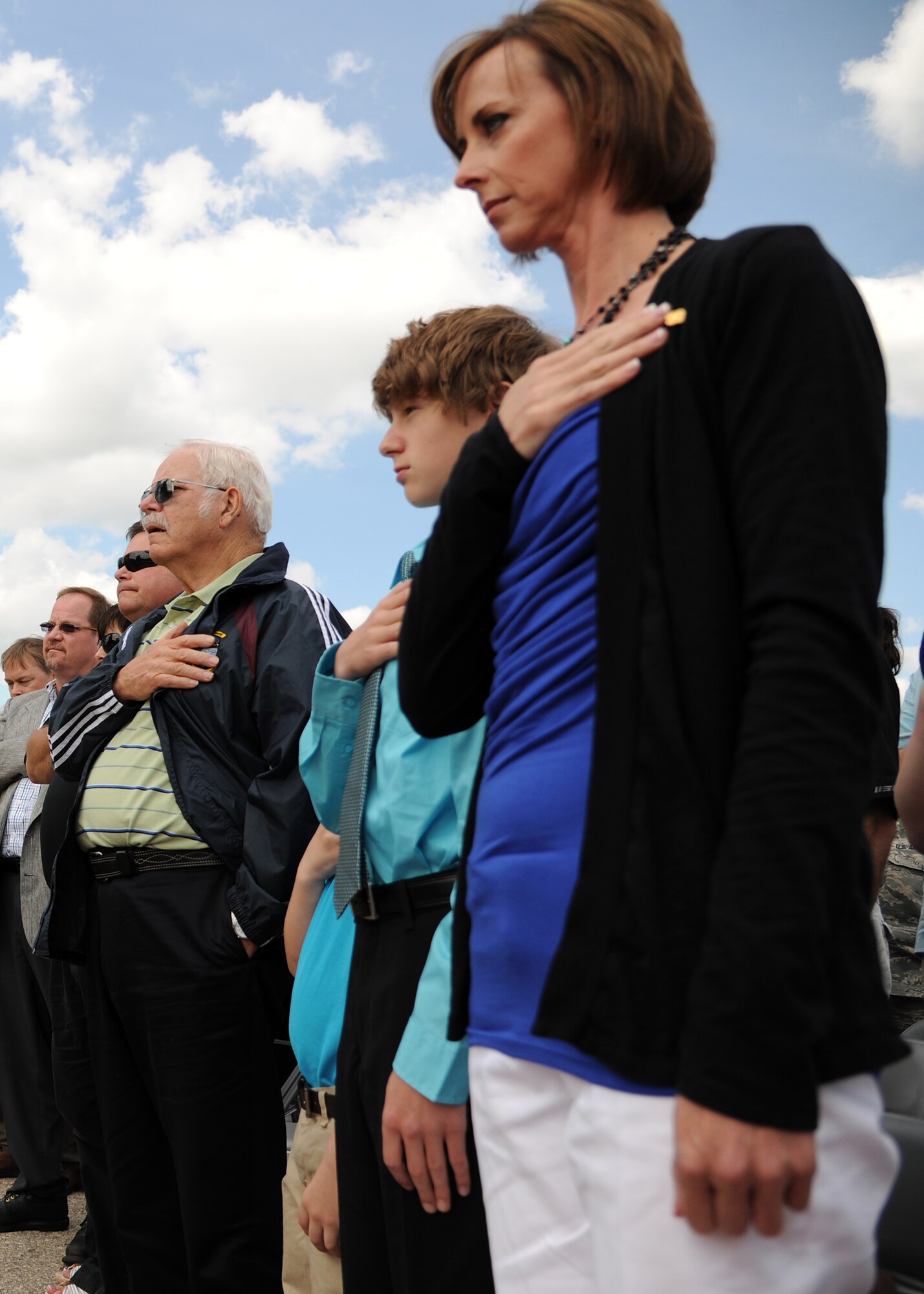Family members of Chief Master Sgt. Harry Walker honor the playing of taps at a rededication ceremony at the Walker Warrior Professional Development Center, on May 30, 2012, on Grand Forks Air Force Base, N.D. (U.S. Air Force photo/Airman 1st Class Ashley N. Taylor)