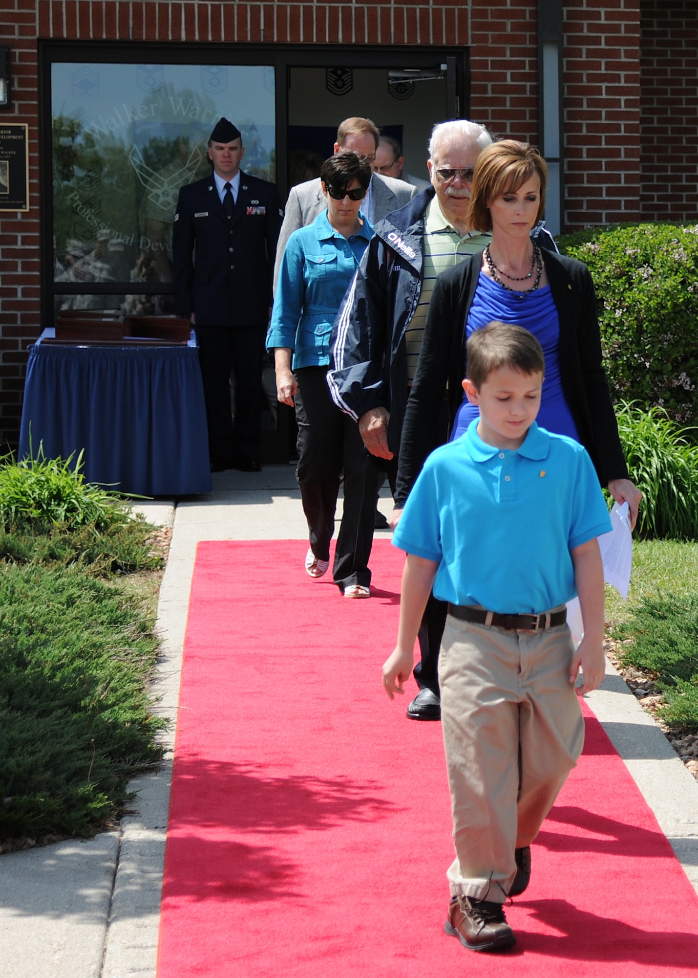 Chief Master Sgt. Harry Walker’s family members walk to their seats during a rededication ceremony at the Walker Warrior Professional Development Center, on May 30, 2012, on Grand Forks Air Force Base, N.D. (U.S. Air Force photo/Airman 1st Class Ashley N. Taylor)   