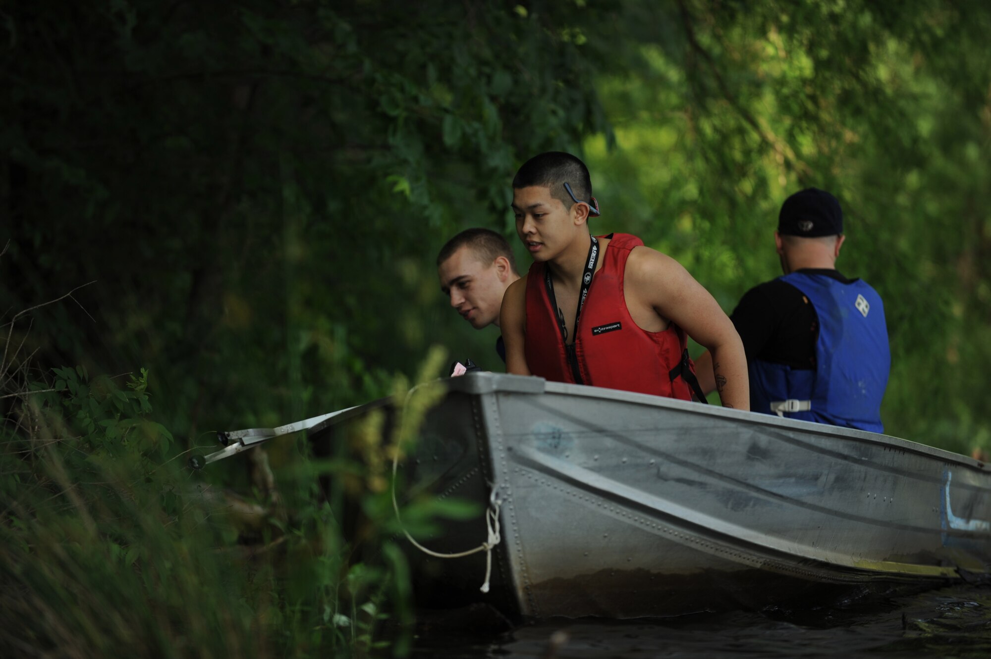 Airmen from the 1st Maintenance Squadron guide a motorboat toward a piece of trash floating in the Chesapeake Bay at Langley Air Force Base, Va., June 2, 2012. The trash collection was part of the 2012 Clean the Bay Day event. (U.S. Air Force photo by Senior Airman Jarad A. Denton/Released)
