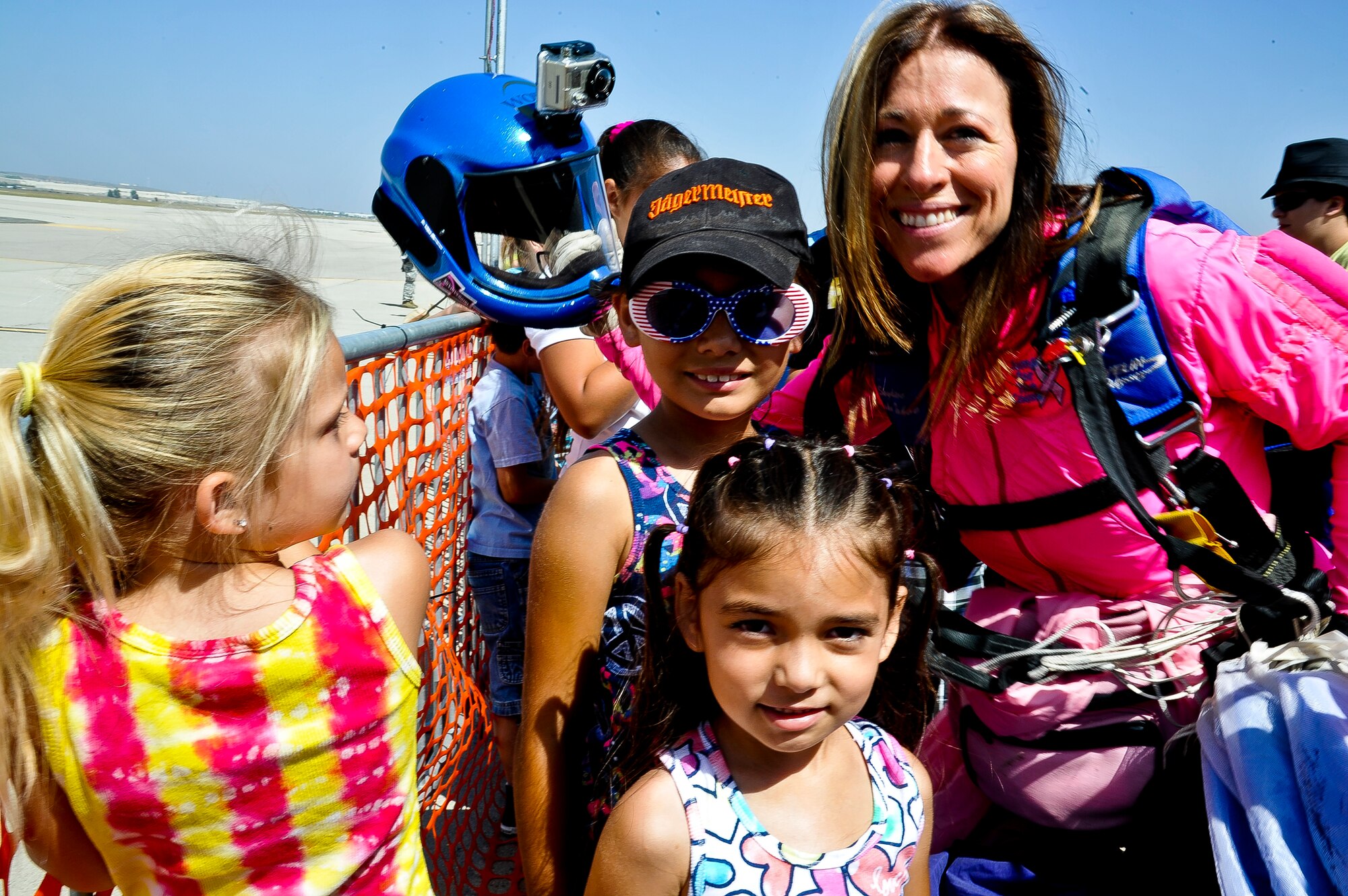 Mary Tortomasi, with the Golden Star Parachute Team, interacts with the crowd after performing aerobatic skills at the air show. (U.S. Air Force photo by TSgt Elizabeth Concepcion)