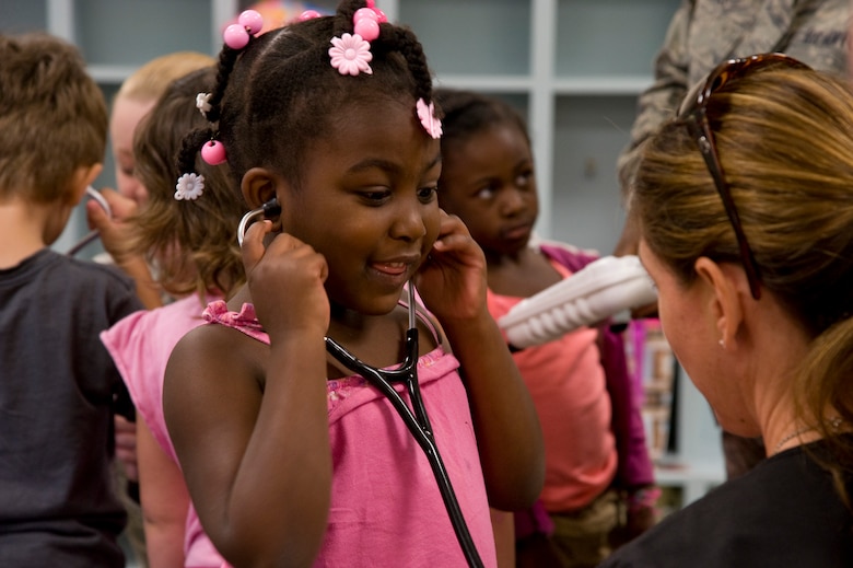 Jennifer Turner, a registered nurse at the 1st Special Operations Medical Operations Squadron, teaches Mya Morehouse, a pre-kindergarten student, how to use a stethoscope at Child Development Center East at Hurlburt Field, Fla., May 10, 2012. Medical technicians and nurses from Hurlburt Field’s clinic spent time teaching children about nursing as part of Nurse and Technician Week. (U.S. Air Force photo / Senior Airman John Bainter) (RELEASED) 
