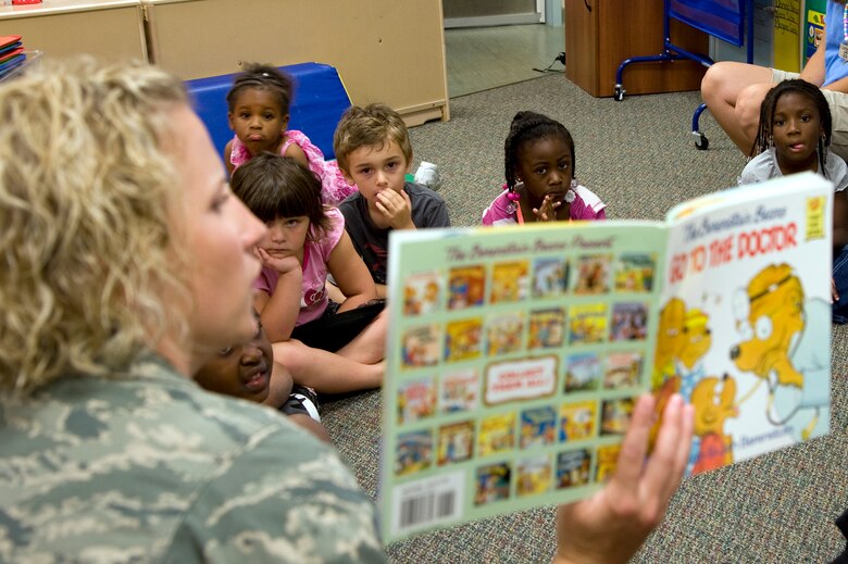 Capt. Jessica Cole, family health clinic nurse manager at 1st Special Operations Medical Operations Squadron, reads “Go to the Doctor” to a class at the Child Development Center East at Hurlburt Field, Fla., May 10, 2012. The story time was part of outreach by nurses and medical technicians from Hurlburt Field’s clinic to spark interest in nursing among children. (U.S. Air Force photo / Senior Airman John Bainter) (RELEASED) 
