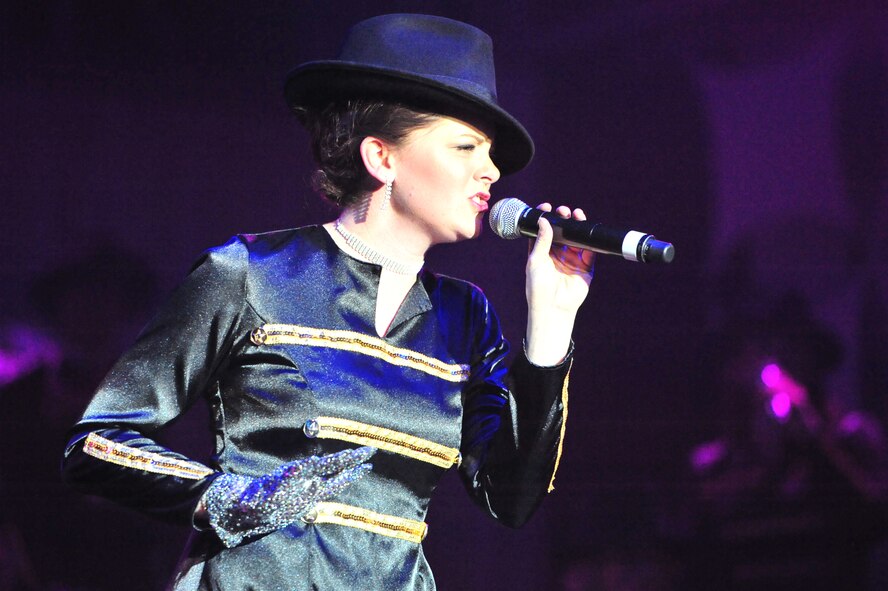 U.S. Air Force 1st Lt. Ashley Elmore, 28th Force Support Squadron Ellsworth Air Force Base, S.D., sings ?Man in the Mirror? as part of a musical tribute to singer Michael Jackson during the first 2012 Tops in Blue performance held at Marshall Auditorium, Clovis, N.M., May 28, 2012. The ensemble provides quality entertainment utilizing talented Airmen from every rank within the force. (U.S. Air Force photo by Airman 1st Class Alexxis Pons Abascal)   
