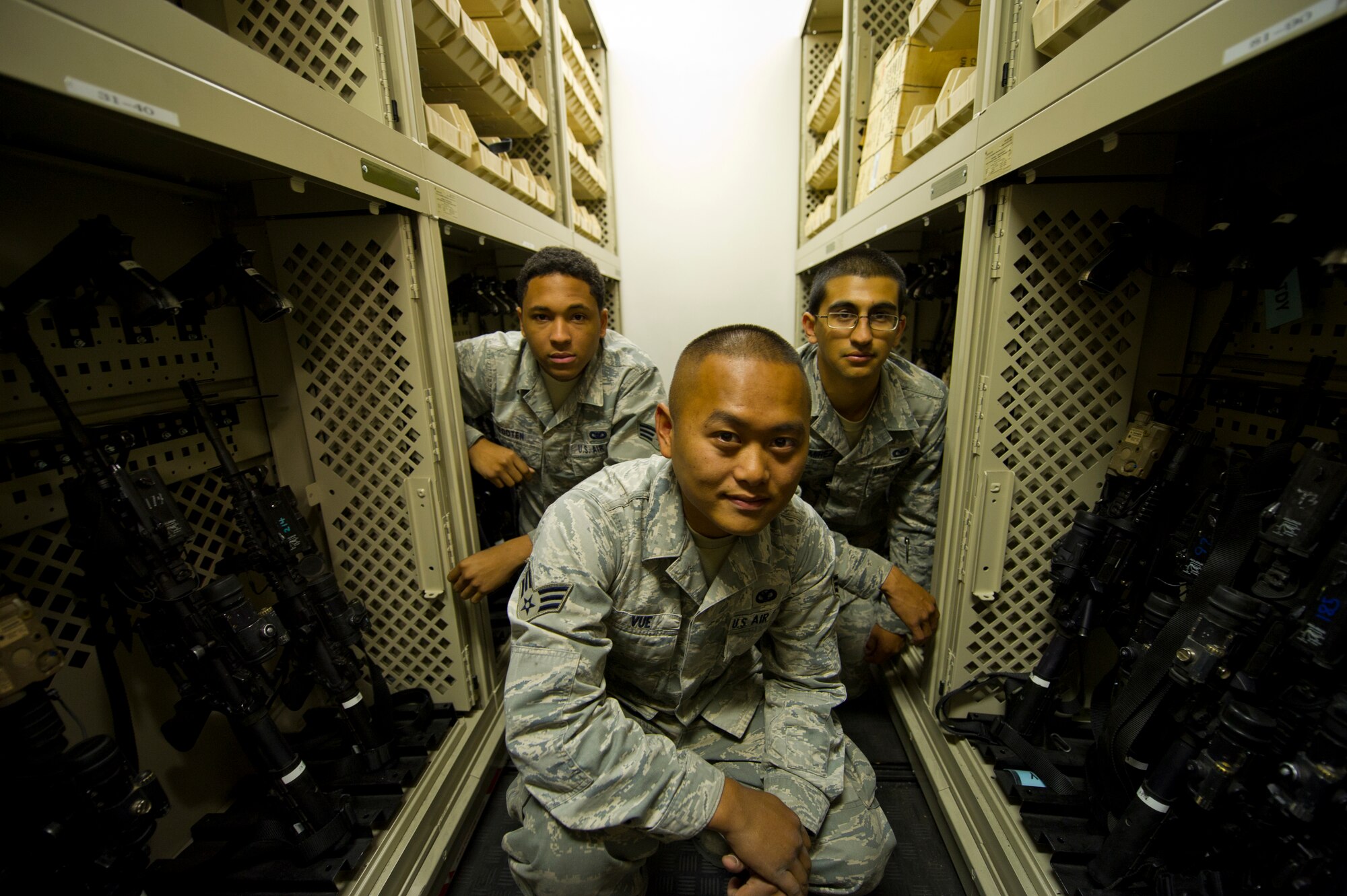 HOLLOMAN AIR FORCE BASE, N.M. - Senior Airman Joaquin Wooten, SrA Michael Vue, and Airman 1st Class Robert Ramirez, 49th Security Forces Squadron armorers, pose for a photo April 30th. These Airmen are part of a small group of security forces personnel who are trained to guard the base's supply of official and personally-owned weapons. More than $2 million worth of equipment is housed within the armory. (U.S. Air Force photo by Airman 1st Class Michael Shoemaker/Released)