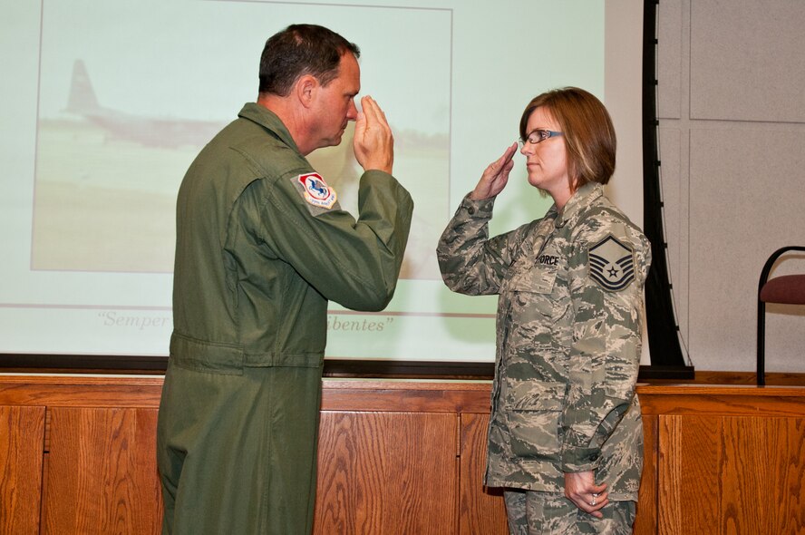 Col. Michael Pankau, 139th Airlift Wing commander, salutes Master Sgt. Heidi Utt for stopping a woman from possibly jumping to her death in an apparent suicide attempt May 24, 2012. (Air National Guard photo by Senior Airman Sheldon Thompson/Released)