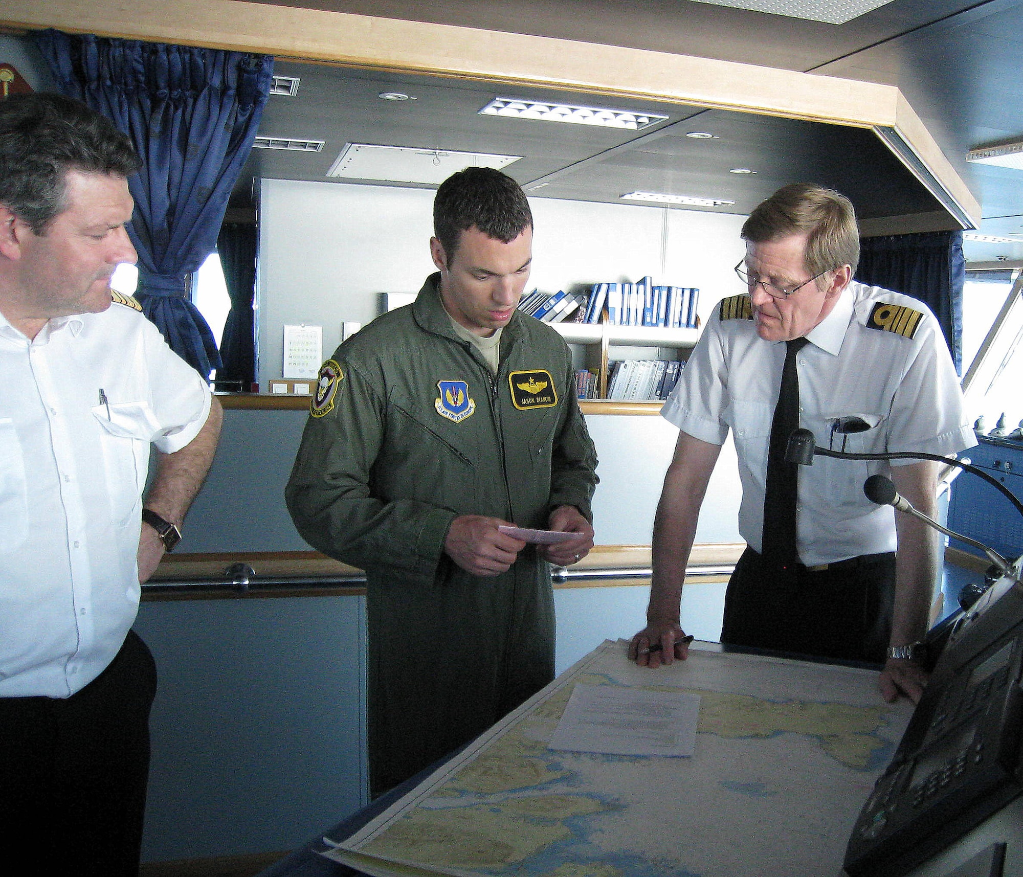 KEFLAVIK, Iceland — From left, Icelandic Coast Guard Capt. Halldor Nellet, U.S. Air Force Maj. Jason Bianchi, 493rd Expeditionary Fighter Squadron F-15C pilot deployed from Royal Air Force Lakenheath, England, and ICG Cmdr. Sigurdur Steinar Ketilsson conduct a mission briefing before a search and rescue exercise off the coast of Iceland May 30, 2012. During the exercise, two F-15C Eagle pilots from the 493rd EFS simulated a bailout scenario over Icelandic waters.  Pararescuemen jumped into the water and provided medical treatment to the “downed” pilot, who was then hoisted to safety by an Icelandic helicopter.  The rescue exercise increased interoperability, as well as developed cohesion between the ICG and the 493rd EFS, which is deployed to Iceland to conduct NATO air policing until June 7, 2012. (Photo Courtesy of Icelandic Coast Guard)                         