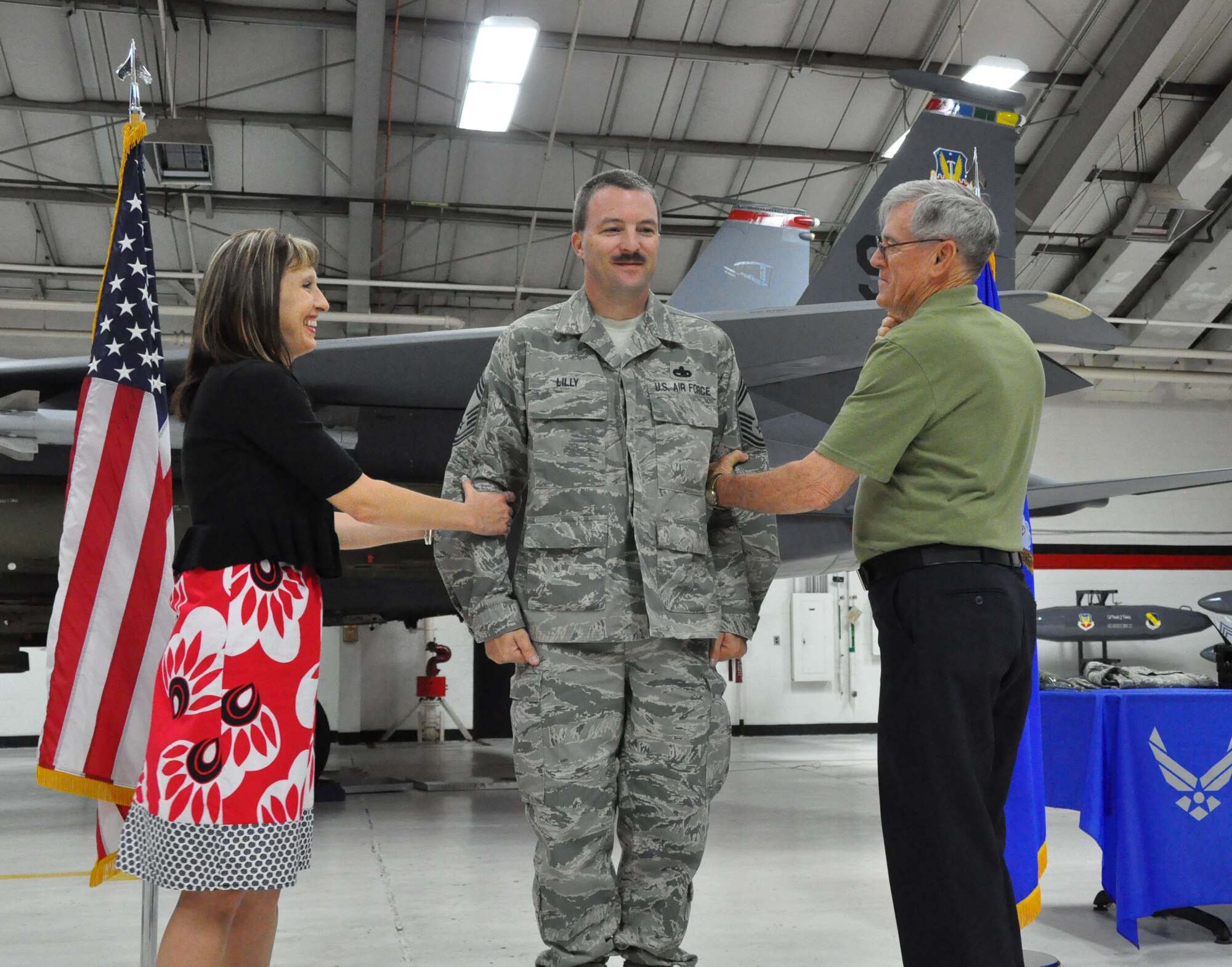 James Lilly, center, pins on the rank of chief master sergeant during a ceremony held on June 2, 2012. Lilly is a reservist with the 414th Fighter Squadron. (USAF by Master Sgt. Wendy Lopedote, 916ARW/PA, released)