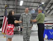 James Lilly, center, pins on the rank of chief master sergeant during a ceremony held on June 2, 2012. Lilly is a reservist with the 414th Fighter Squadron. (USAF by Master Sgt. Wendy Lopedote, 916ARW/PA, released)