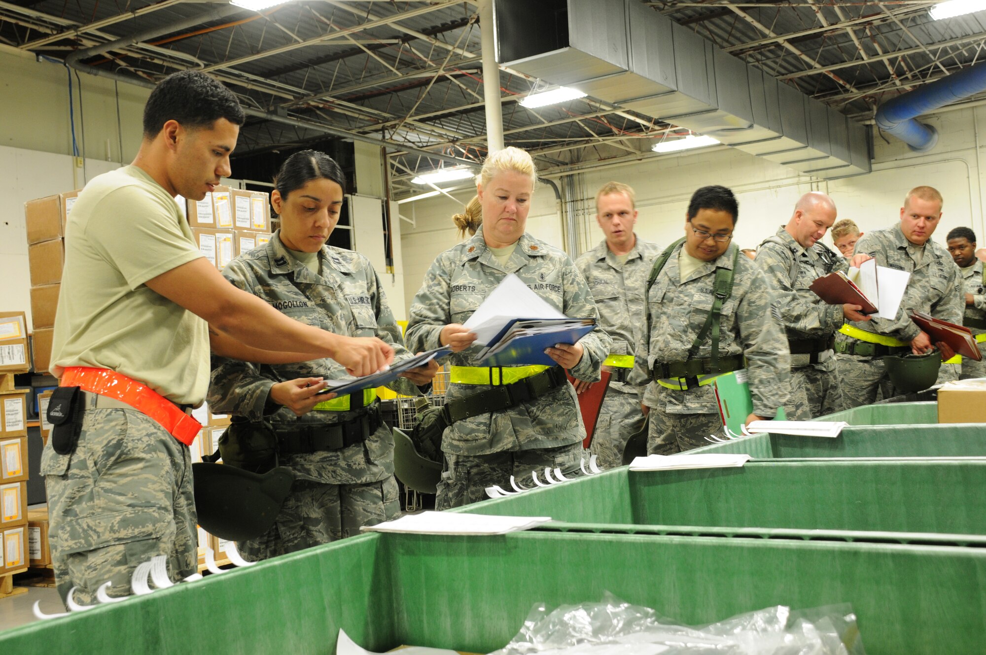 Airman First Class Diego Llanes, 6th Logistics Readiness Squadron, assists Captain Carolina Mogollon, 927th Aeromedical Staging Squadron, as she processes through a mobility line June 2, 2012 at MacDill Air Force Base, Fla.  Mogollon is a reservist with the 927th Air Refueling Wing and was participating in a mobility exercise designed to simulate a deployment.  