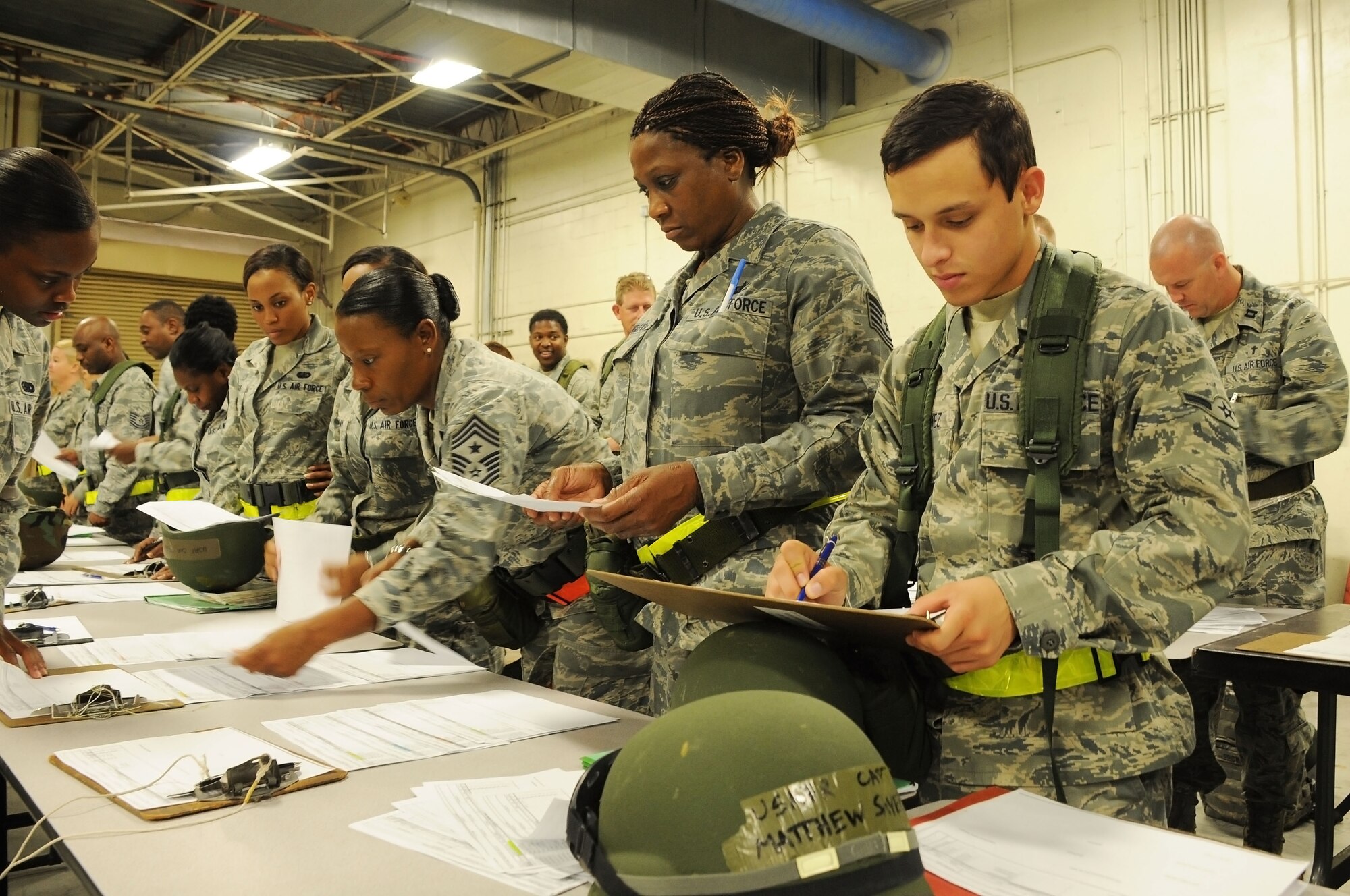 Members of the 927th Air Refueling Wing, a reserve unit of more than 800 Airmen, review the contents of mobility bags as they prepare to pick up gear for a mock deployment June 2, 2012 at MacDill AFB, Fla. Several units in the 927th ARW were participating in a mobility exercise designed to help Airman prepare for deployments by demonstrating the items and steps needed to deploy.  