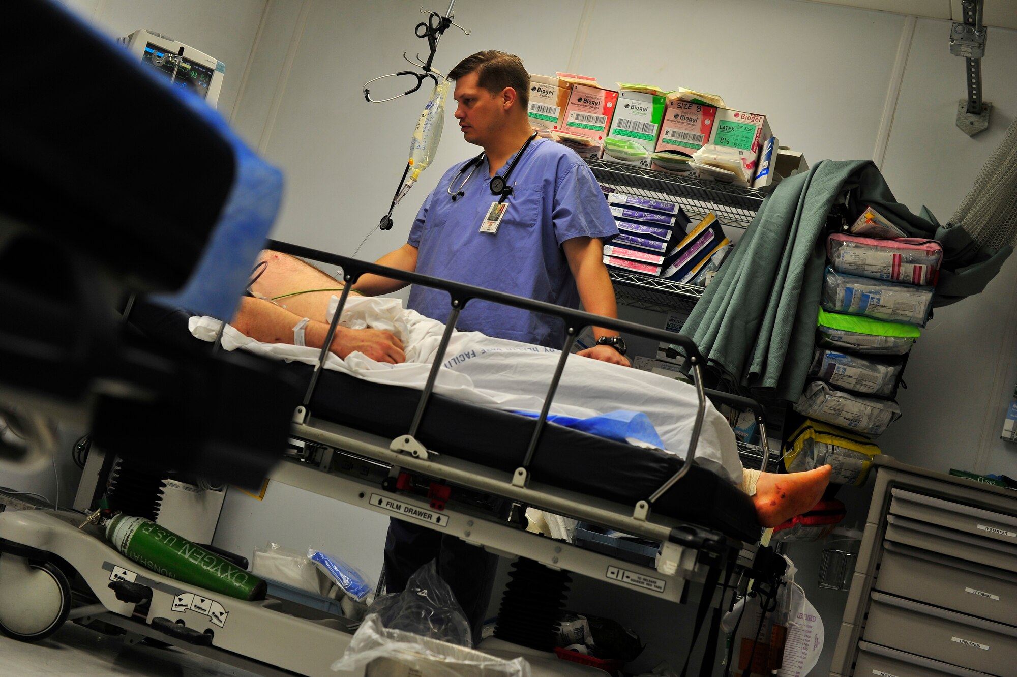 Air Force Dr. (Maj.) Roy Johnson, Craig Joint-Theater Hospital flight commander for the emergency room department, checks in on patients at Bagram Airfield, Afghanistan, June 1, 2012. CJTH is one of the largest and best-equipped trauma facilities in Afghanistan.(U.S. Air Force photo/Staff Sgt. Clay Lancaster)