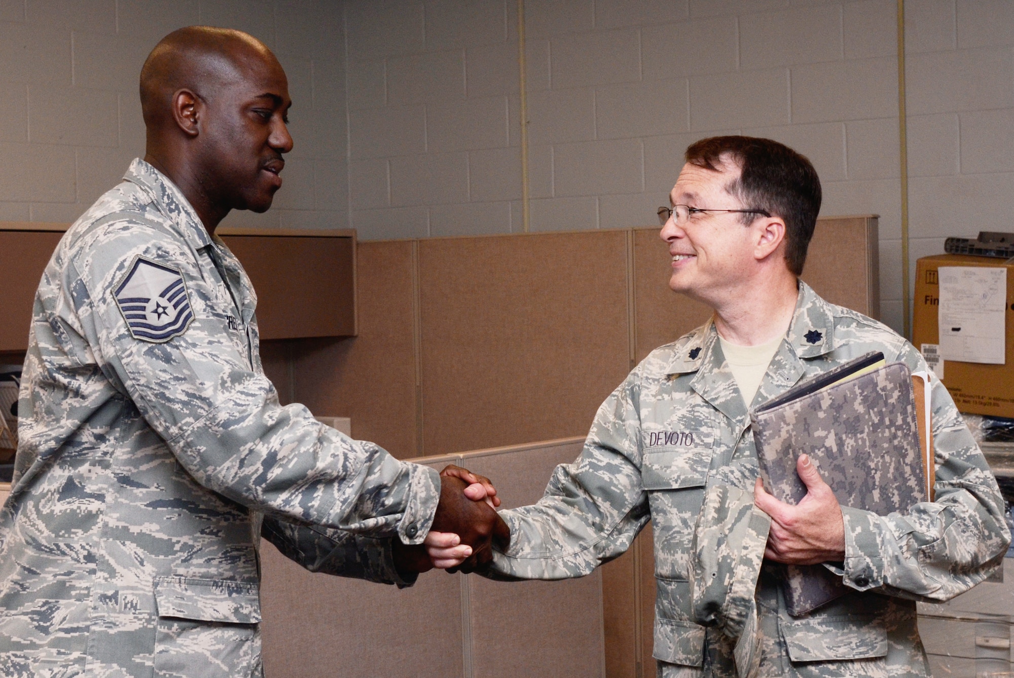 DOBBINS AIR RESERVE BASE, Ga. - Lt. Col. Kim Devoto thanks Master Sgt. Clarence Greene III and his team for their assistance as he completes his deployment processing through the Centralized Deployment Processing Center, Dobbins Air Reserve Base, Ga., May 25. Devoto was the first Individual Reservist to return through the CDPC. (U.S. Air Force photo/Don Peek)