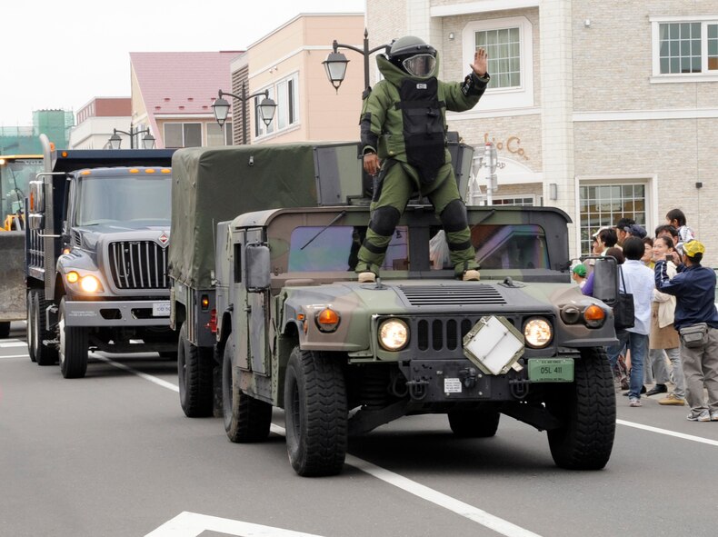 U.S. Air Force Tech. Sgt. Michael Overton, 35th Civil Engineer Squadron explosive ordnance disposal technician, displays a bomb suit during the parade at the 24th Annual American Day at Misawa City, Japan, June 3, 2012. Many Air Force vehicles were displayed during, including 35th Security Forces patrol vehicles, a 35 CES fire truck and more. (U.S. Air Force photo by Airman 1st Class Kaleb Snay/Released)