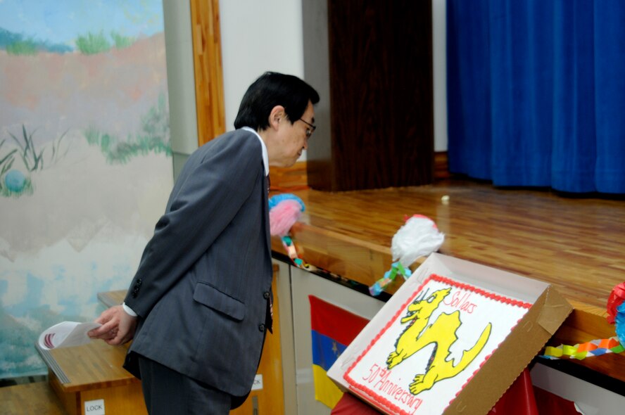 Takayuki Fukushi, Vice President of the Aomori Branch League for Soroban Education of Japan, Inc., admires the Sollars 50th Anniversary cake at Misawa Air Base, Japan, June 1, 2012. Sollars Elementary School celebrated its 50th year holding the name. (U.S. Air Force photo by Airman 1st Class Zachary Kee/ Released)