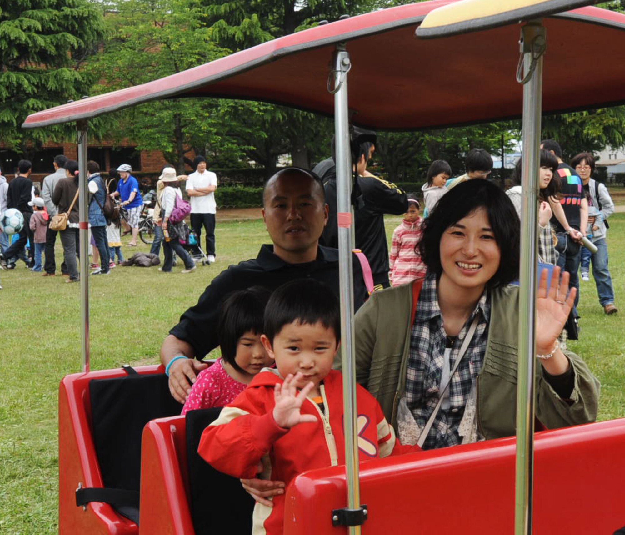 A Japanese family rides the train around Train Park during the 24th Annual American Day celebration at Misawa City, Japan, June 3, 2012. The festival allows the base community to share American traditions with the Misawa community. (U.S. Air Force photo by Airman Kenna Jackson/Released)