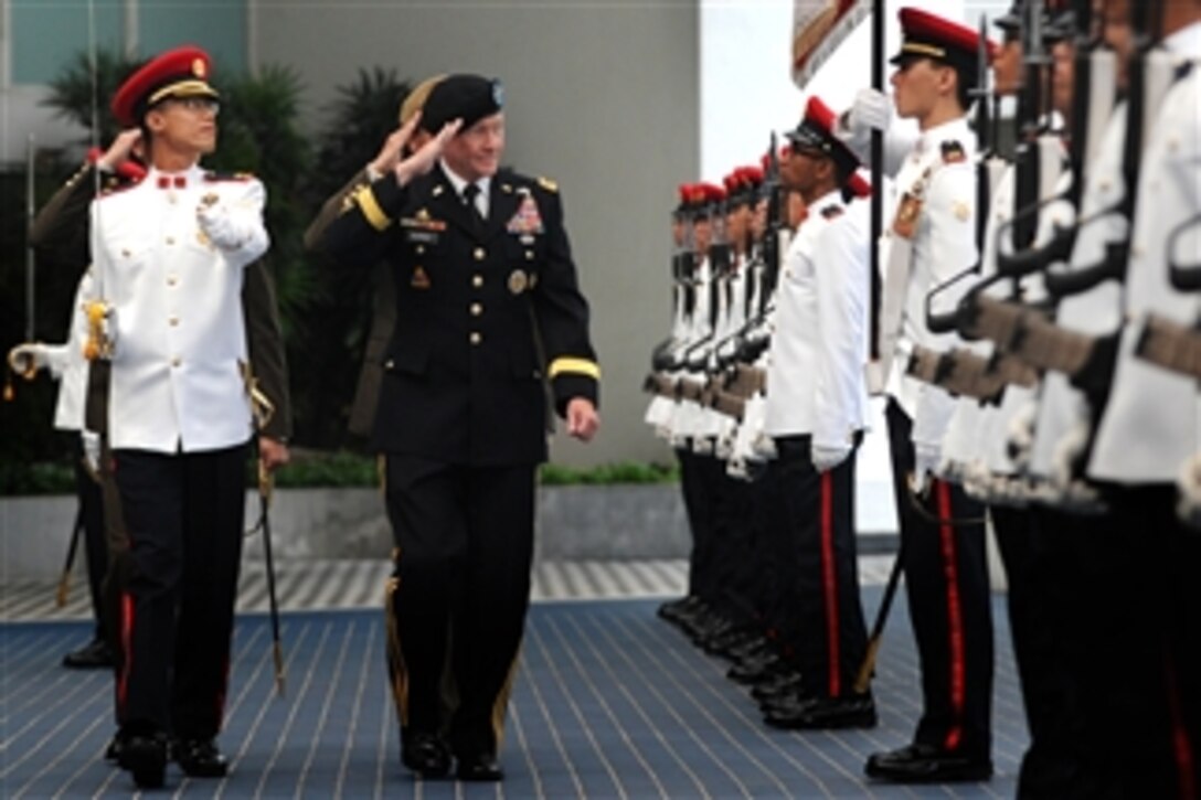 Chairman of the Joint Chiefs of Staff Gen. Martin E. Dempsey salutes the Singapore Honor Guard as he inspects the troops during welcoming ceremonies for him in Singapore on June 1, 2012.  Dempsey is in Singapore to attend the Shangri-La Dialogue.  