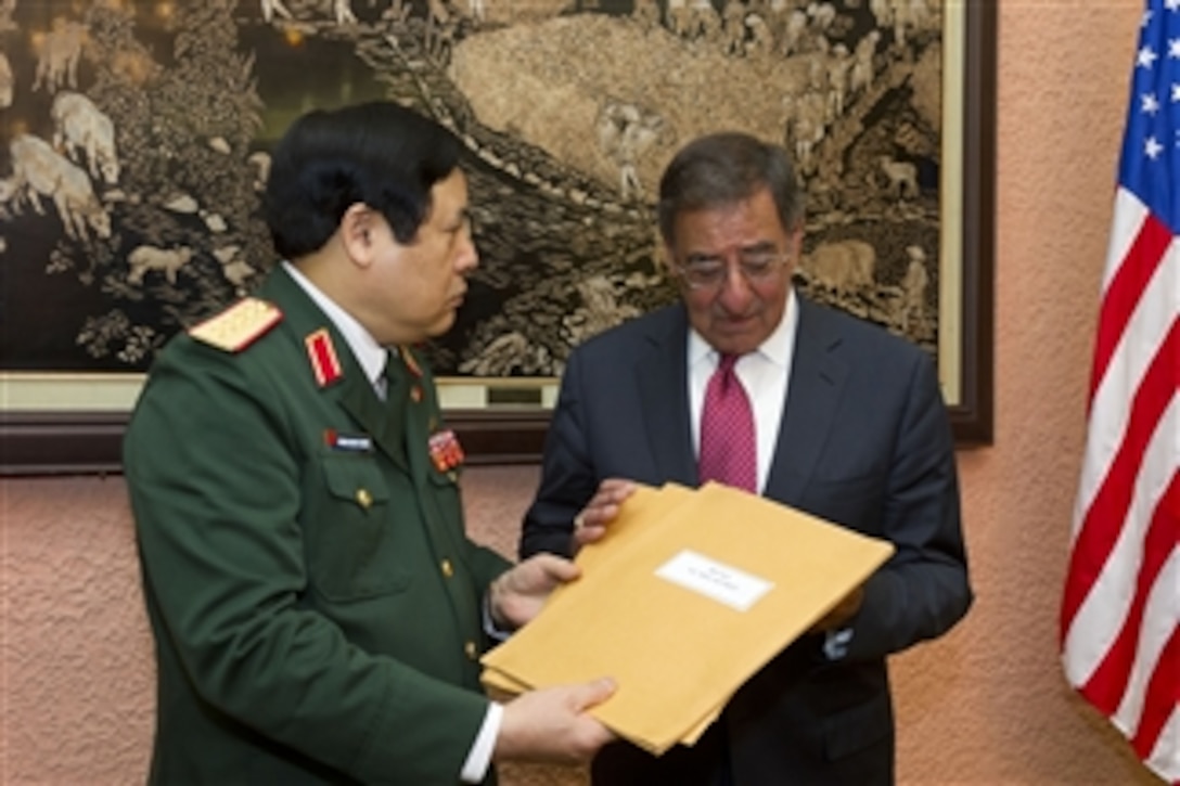 Secretary of Defense Leon E. Panetta accepts letters written by American service members from Vietnamese Minister of National Defense Senior Lt. Gen. Phuong Quang Thanh in Hanoi, Vietnam, on June 4, 2012.  Panetta returned a diary written by Vietnamese soldier Vu Dinh Doan as part of an exchange of artifacts taken by service members from both nations during the Vietnam War.  
