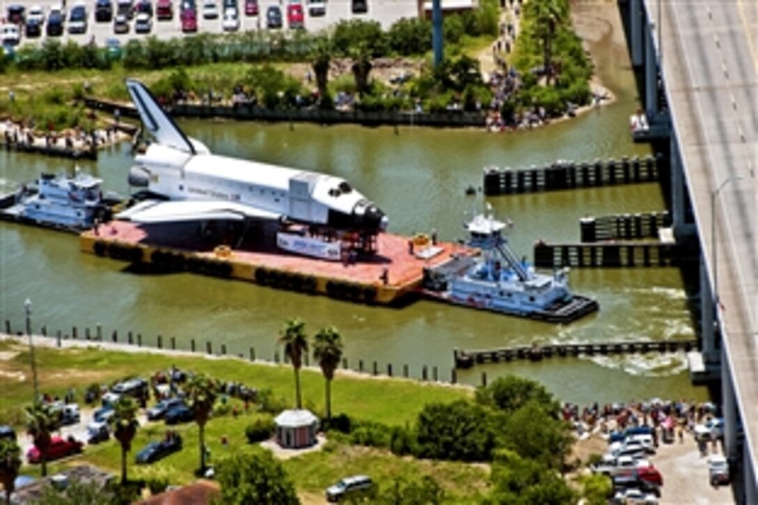 Coast Guard units and other law enforcement agencies help escort a NASA training shuttle to the Nassau Bay Hilton Hotel dock in League City, Texas, June 1, 2012.
