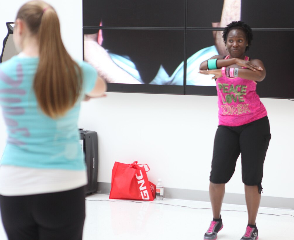 An instructor demonstrates the choreography of Zumba during a class held at the Marine Corps Exchange aboard Marine Corps Base Camp Lejeune, May 25. Zumba follows steps from salsa, merengue and belly dancing along with other styles of dance for a high-energy workout.  