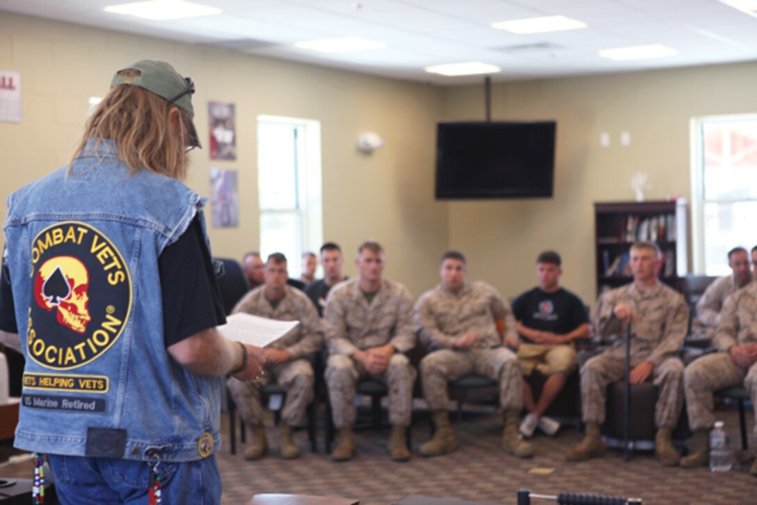 H.L. Huchi, North Carolina Combat Veterans Motorcycle Association 15-4 commander, speaks with Marines about the association during a visit to the Wounded Warrior Battalion-East aboard Marine Corps Base Camp Lejeune May 23.  