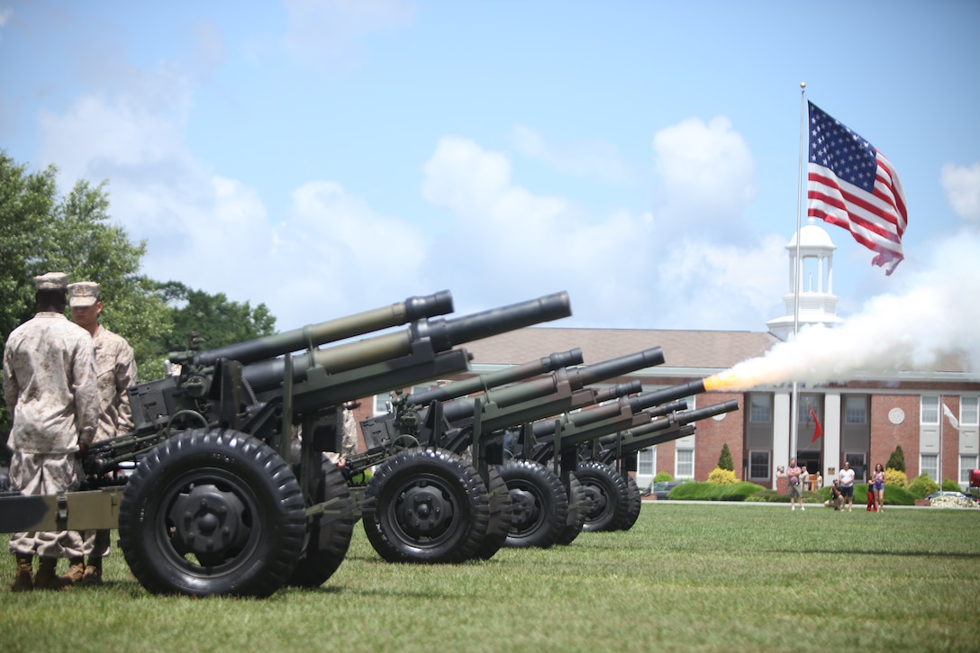 Marines with Battery K, 3rd Battalion, 10th Marine Regiment, fire off blank rounds during the Memorial Day 21-gun salute ceremony on W.P.T. Hill Field, in front of Building 1, aboard Marine Corps Base Camp Lejeune May 28.