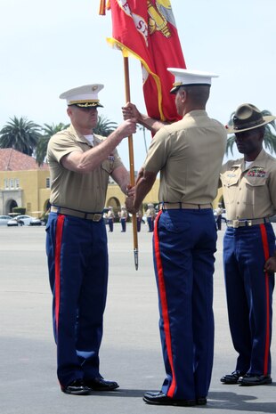 Sgt. Maj. Terrence Whitcomb (right), 2nd Recruit Training Battalion sergeant major, Recruit Training Regiment, salutes Lt. Col. Reginald Hairston (middle), as he passes the colors to relinquish his post to Lt. Col. Daren Erickson (left), 2nd RTBns oncoming commanding officer, aboard Marine Corps Recruit Depot San Diego June 1. The passing of the colors symbolizes the passing of responsibility and authority. 