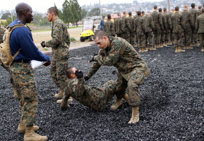 Sgt. Christian Hutson, drill instructor, Company K, 3rd Recruit Training Battalion test recruit in Marine Corps Martial Arts Program tan belt moves May 23 aboard Marine Corps Recruit Depot San Diego. The test consisted of six stationes, each with various MCMAP moves Co. I recruits have learned over the nine weeks prior to their test. Co. I will graduate June 15 with tan belts and the title Marine.