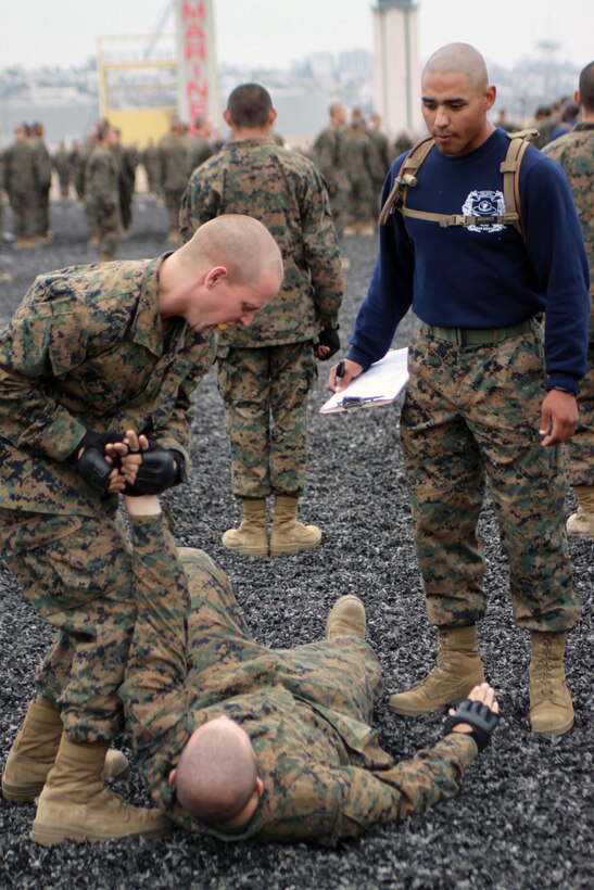 Company I recruits demonstrate various hand manipulations May 23 aboard Marine Corps Recruit Depot San Diego. Co. I completed their Marine Corps Martial Arts Program tan belt test that consisted of basic MCMAP moves. This is only one of the many requirements recruits must accomplish during the 12-weeks of recruit training to earn the title Marine.