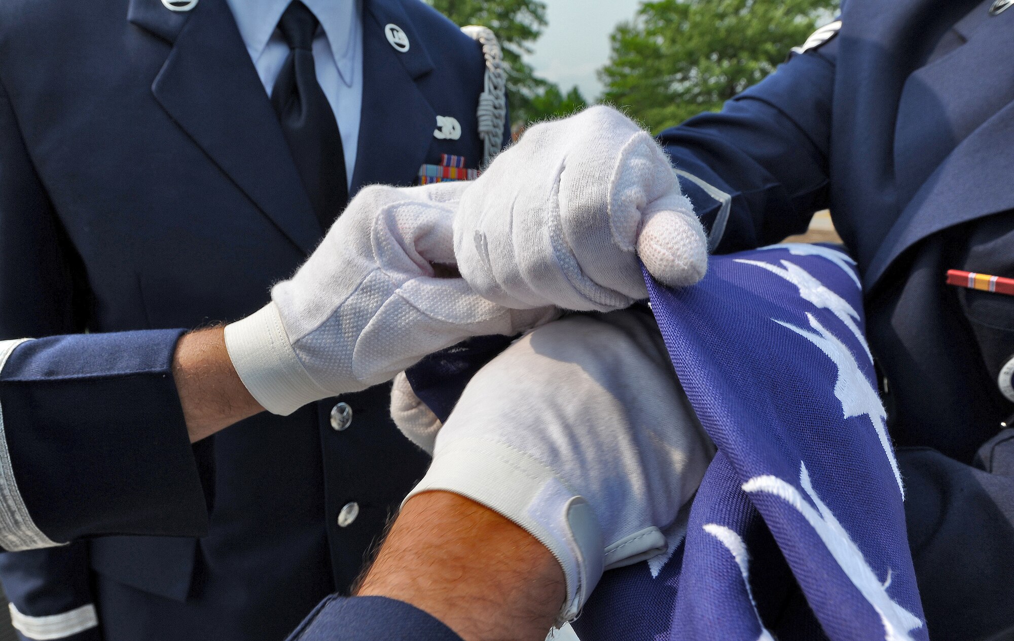 WHITEMAN AIR FORCE BASE, Mo. -- Ceremonial guardsmen from the 509th Bomb Wing perform the final touches of a flag fold during a Wing Retreat Ceremony May 24, 2012. To end the 2012 spring Wingman Day and Critical Days of Summer campaign, Team Whiteman participated in a Wing Retreat Ceremony in honor of Memorial Day. (U.S. Air Force photo/Senior Airman Nick Wilson) (Released)