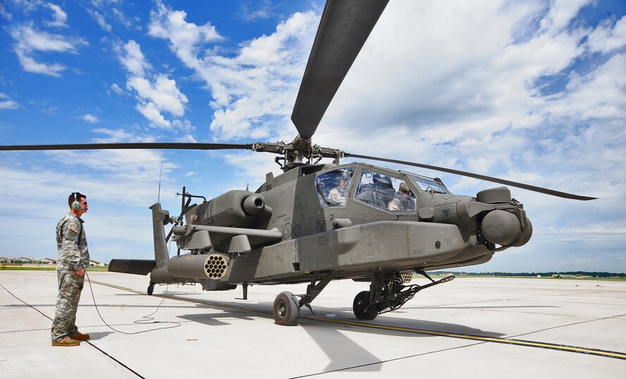 WHITEMAN AIR FORCE BASE, Mo. -- U.S. Army Sgt. Keno Davidson, 135th Attack Reconnaissance  Battalion AH-64D Apache Longbow crew chief, performs pre-flight checks on an Army AH-64D Apache Longbow April 24, 2012. Soldiers like Davidson are dedicated to providing necessary maintenance to keep the Longbows in the sky. (U.S. Air Force photo/Senior Airman Nick Wilson) (Released)