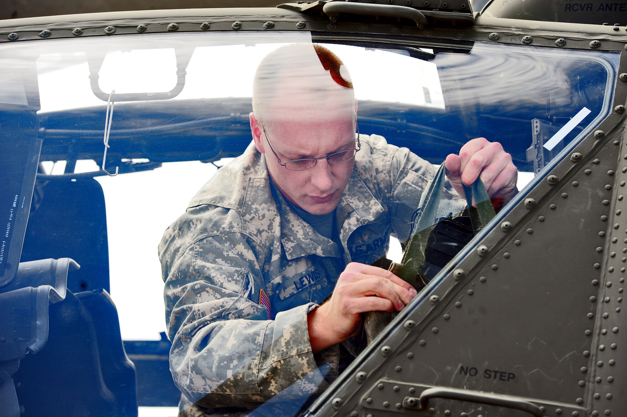WHITEMAN AIR FORCE BASE, Mo. -- U.S. Army Capt. Joel A. Lewis, 1-135th Attack Reconnaissance Battalion AH-64D Apache Longbow pilot, performs a pre-flight check on an AH-64D Apache Longbow April 24, 2012. The combination advanced radar and navigation capabilities and a state-of-the-art avionics suite provide increased situational awareness, lethality and survivability. (U.S. Air Force photo/Senior Airman Nick Wilson) (Released)