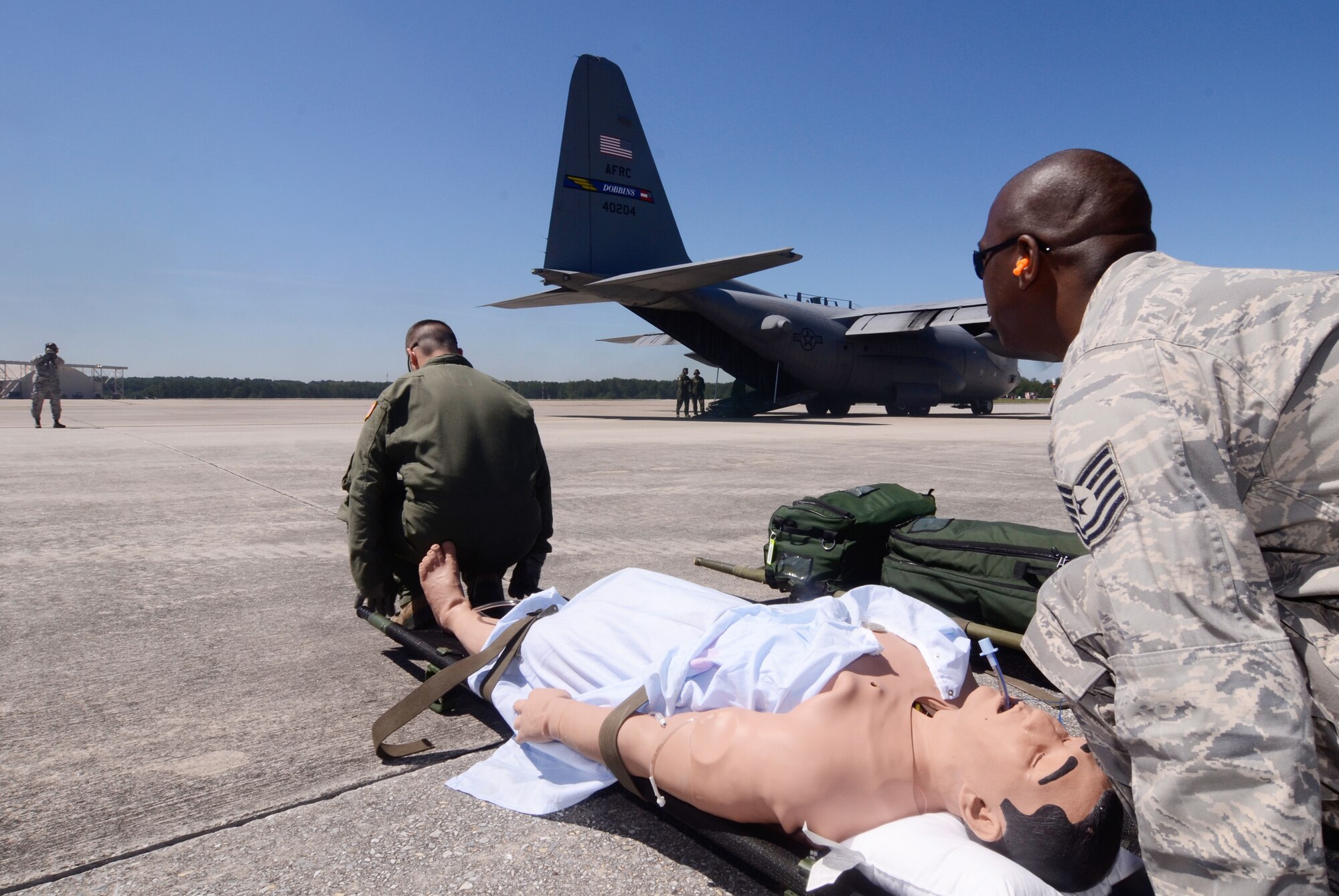 Reservists from the 94th Aeromedical Evacuation Squadron prepare to load a simulation patient during a medical evacuation scenario demonstrated for visiting employers touring Dobbins for Employer Appreciation Day May 2. (U.S. Air Force photo/Don Peek)