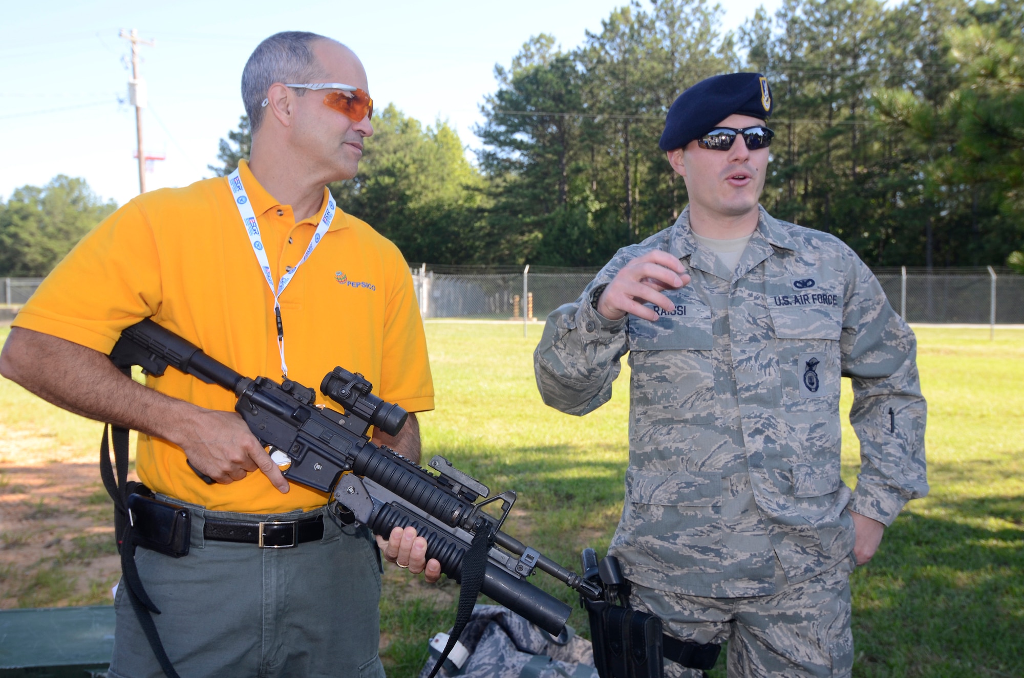 Staff Sgt. David N. Raissi from the 94th Security Forces Squadron briefs visiting employers on weapons and equipment used by security forces personnel during an Employer Appreciation Day tour of Dobbins May 2. (U.S. Air Force photo/Don Peek)
