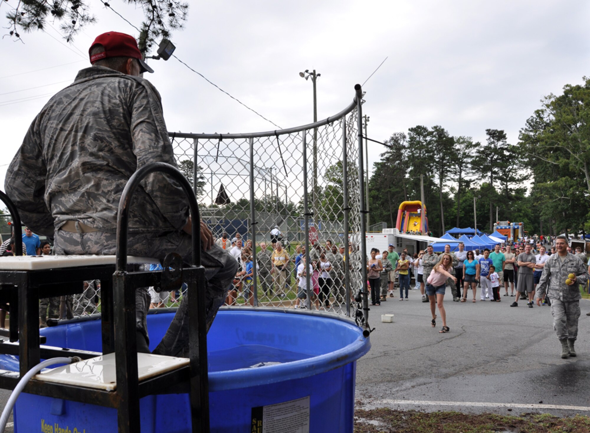 Col. Timothy E. Tarchick, 94th Airlift Wing commander, attempts to taunt his would-be dunker, Master Sgt. Elena M. Lund, 94th Airlift Wing law office superintendent, at Family Day on June 3. (U.S. Air Force photo/Senior Airman Elizabeth Gaston)